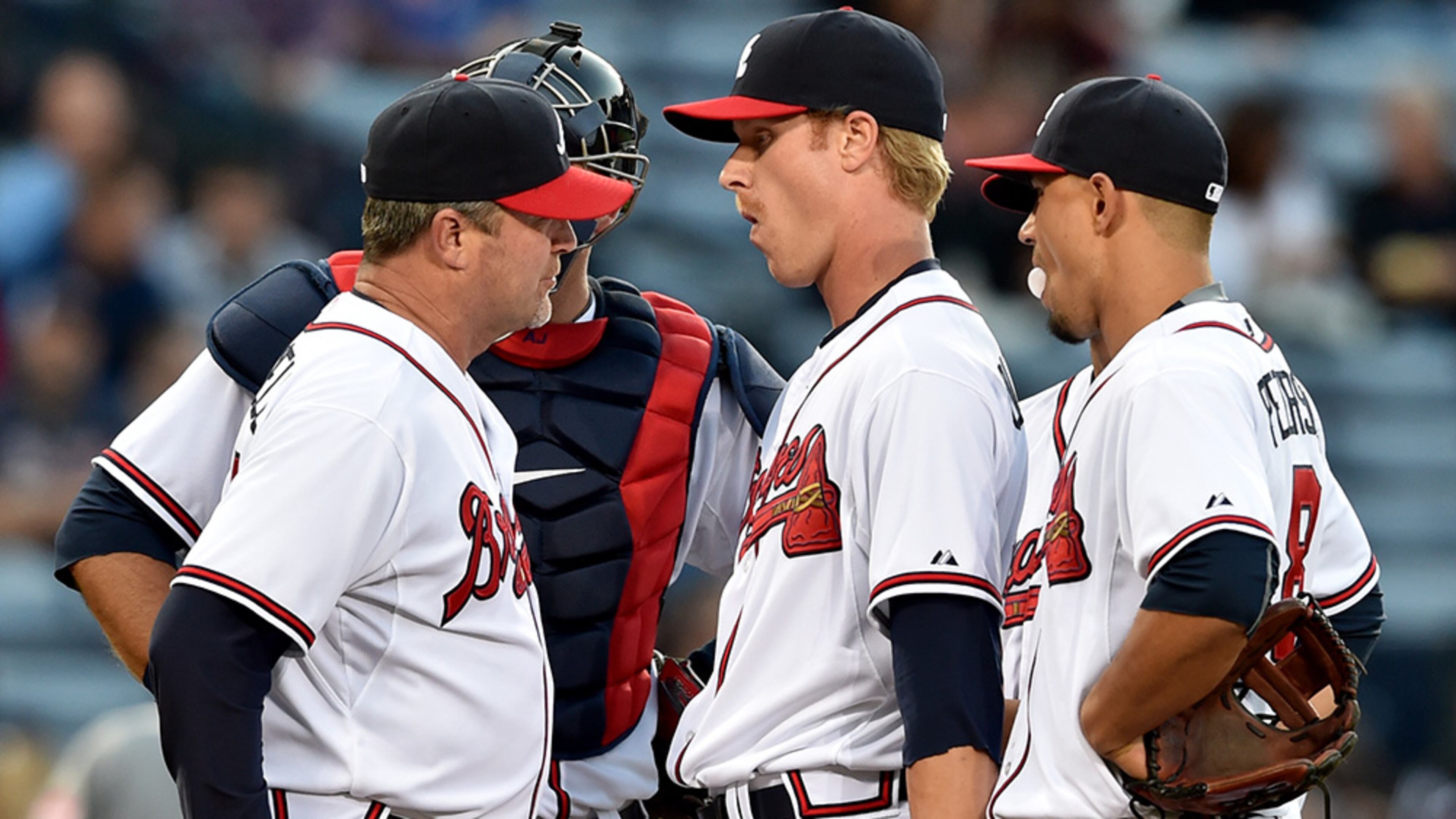 Atlanta Braves pitching coach Roger McDowell (left) makes a first inning visit to the mound to talk with pitcher Mike Foltynewiez, who gave up three hits and two runs in the first inning against the Cincinnati Reds at Turner Field Friday, May 1, 2015.