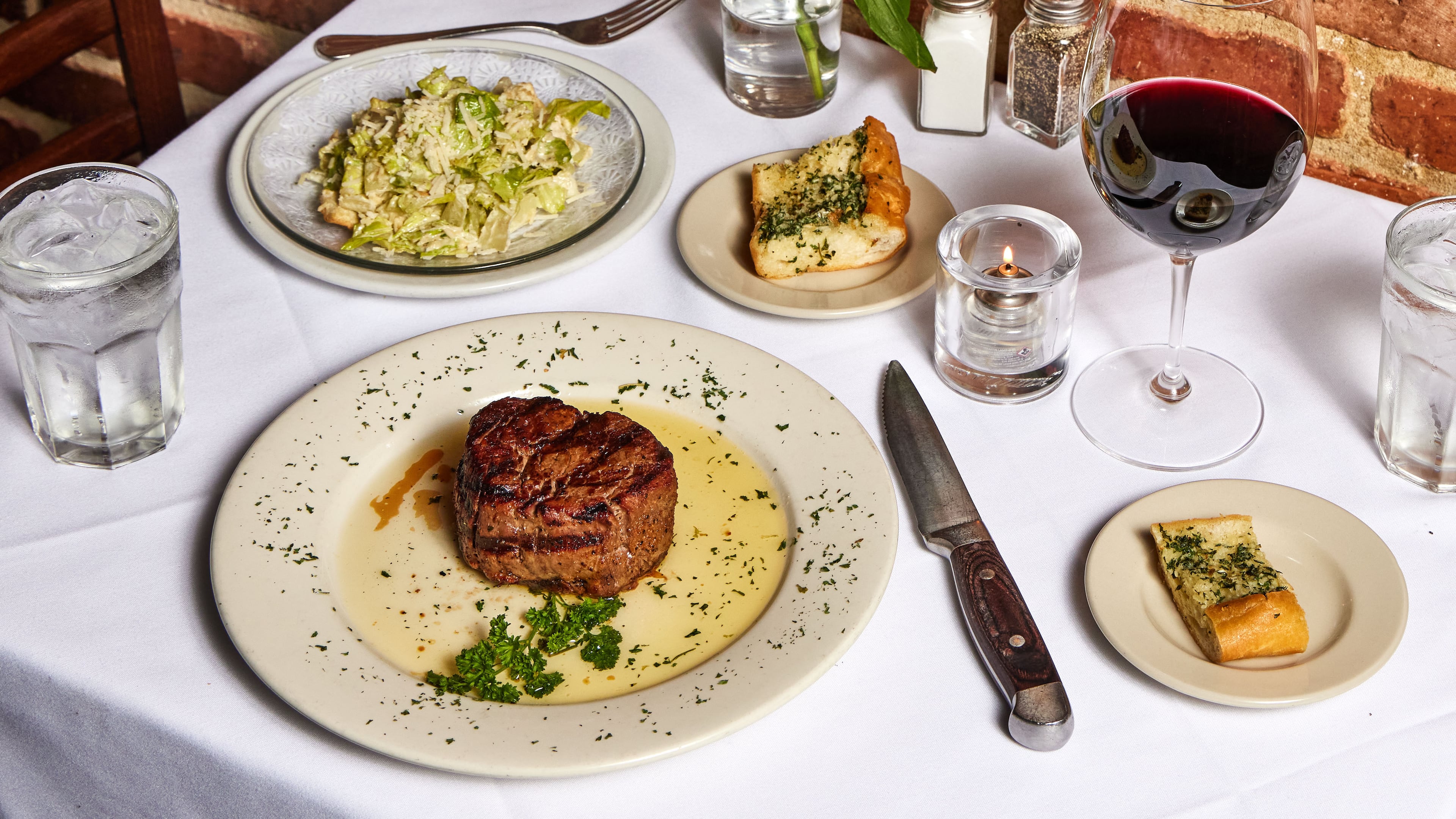 Hal's the Steakhouse takes inspiration from New Orleans, with plenty of seafood on the menu, That doesn't mean you can't get steak, caesar salad and a glass of red wine. It's a steakhouse, after all. (Bailey Garrot for the AJC)