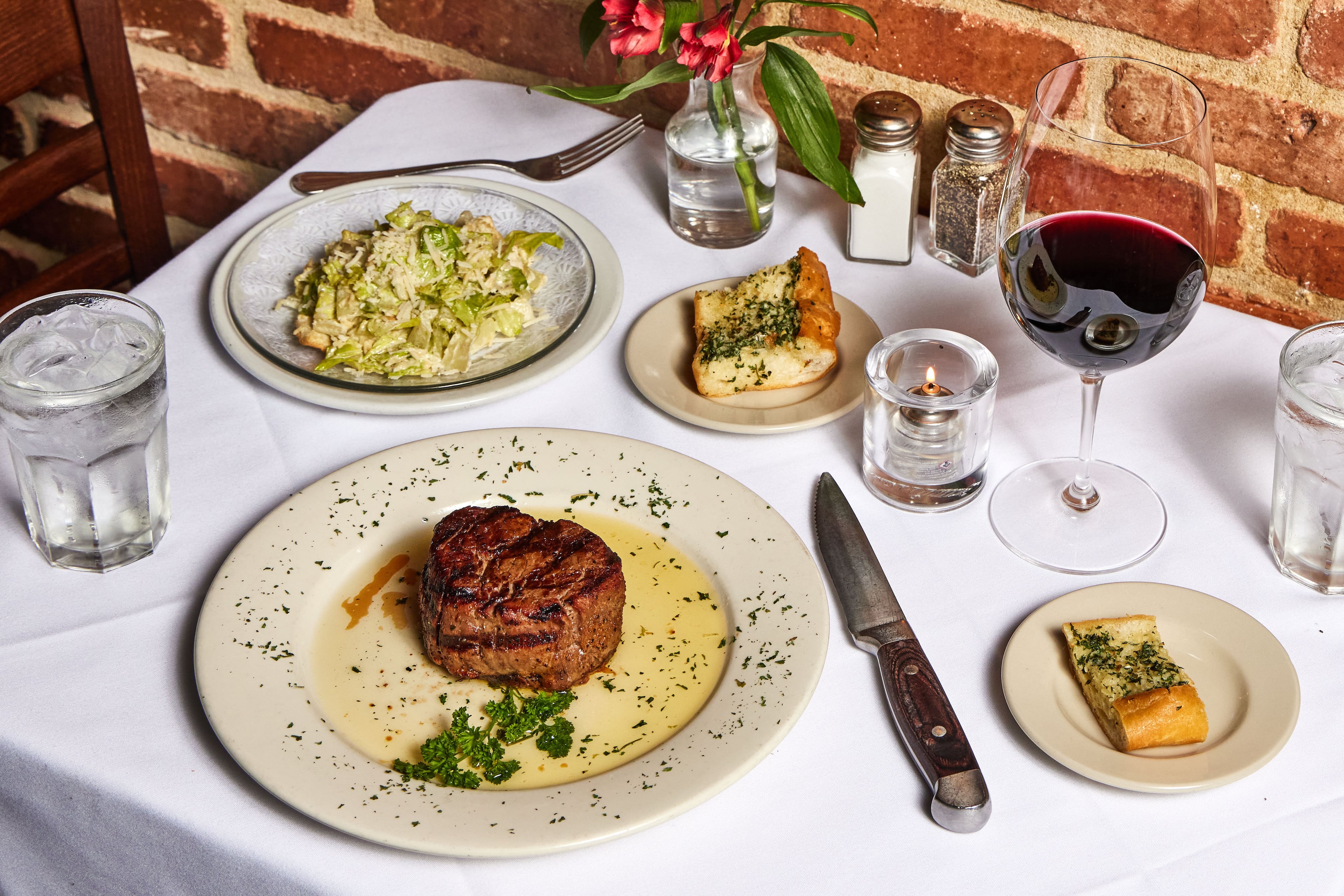 Hal's the Steakhouse takes inspiration from New Orleans, with plenty of seafood on the menu, That doesn't mean you can't get steak, caesar salad and a glass of red wine. It's a steakhouse, after all. (Bailey Garrot for the AJC)