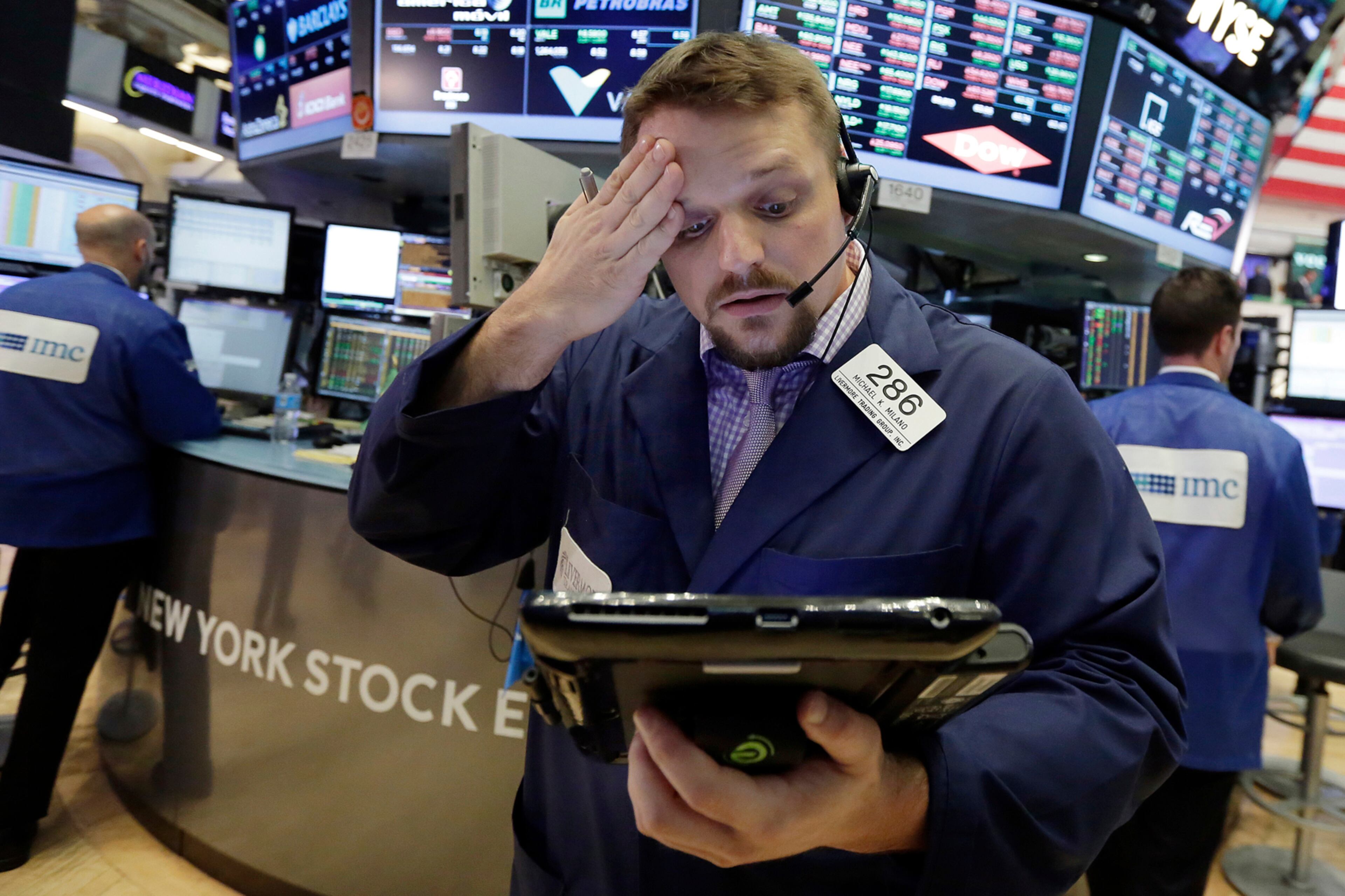 Trader Michael Milano works on the floor of the New York Stock Exchange, Tuesday, June 27, 2017. Stocks are opening slightly lower on Wall Street, led by declines in phone and technology companies. (AP Photo/Richard Drew)