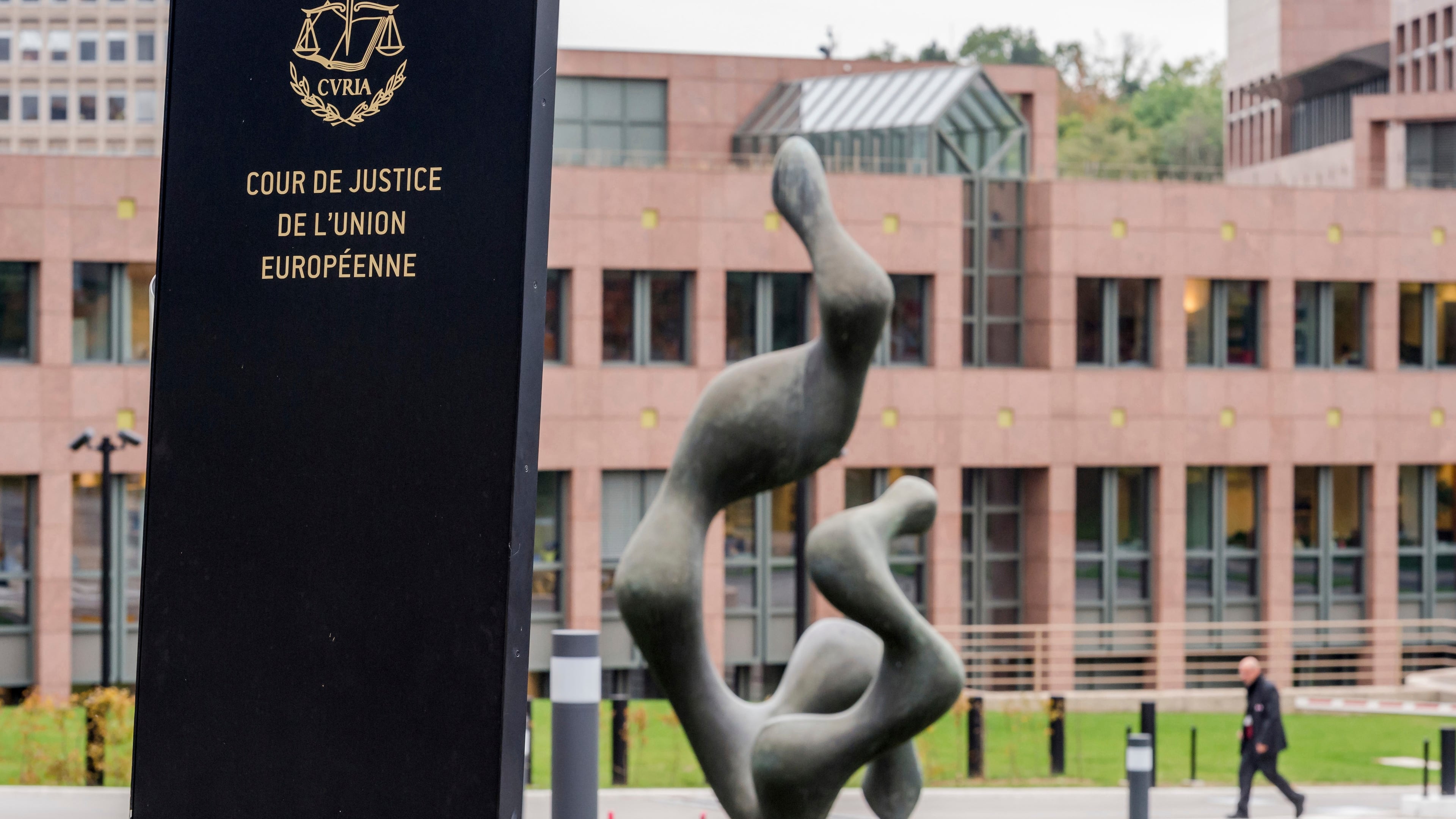 FILE - A man walks by the European Court of Justice in Luxembourg, Oct. 5, 2015. (AP Photo/Geert Vanden Wijngaert, File)