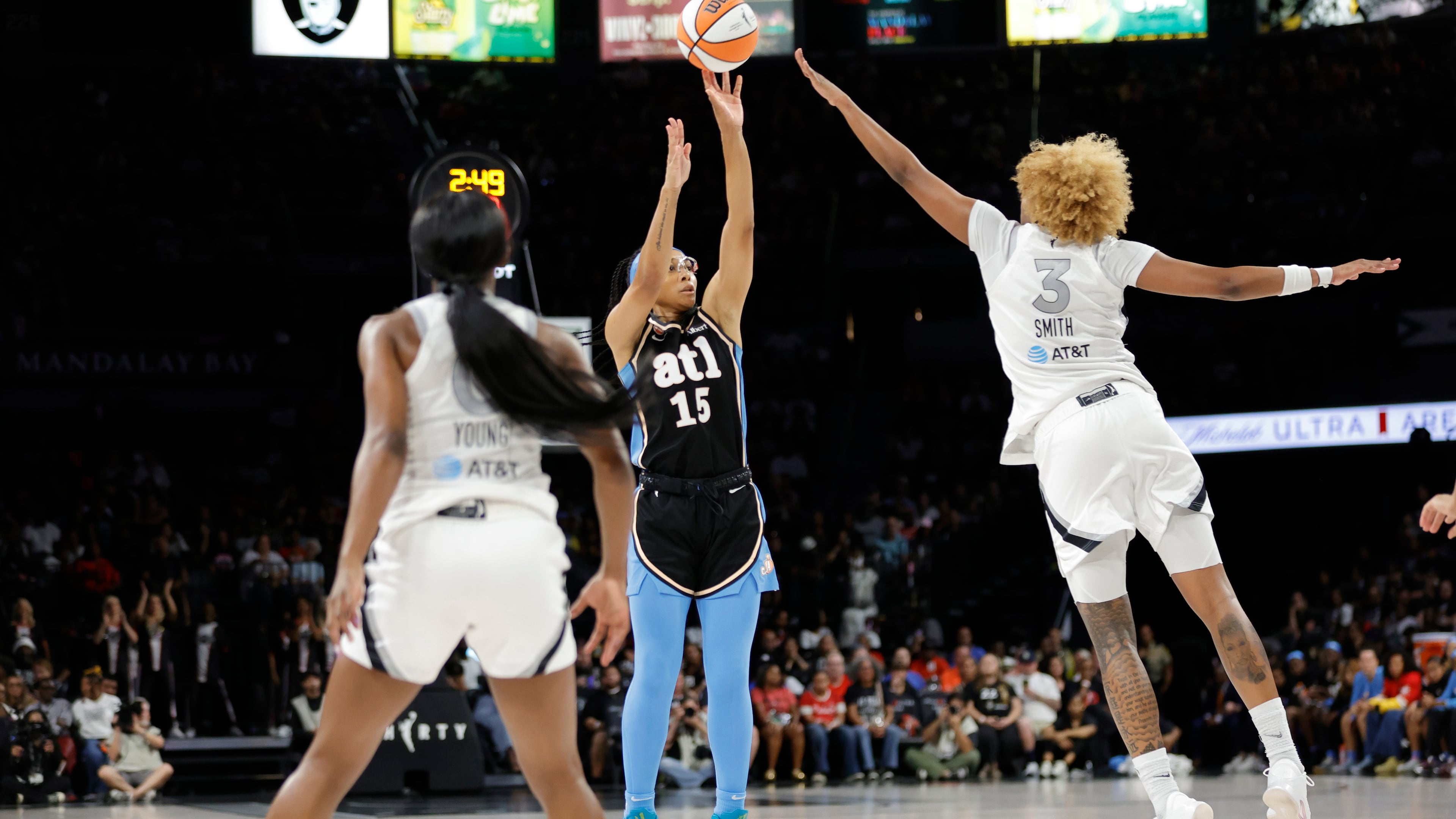 Atlanta Dream guard Allisha Gray shoots between Las Vegas Aces guard Jackie Young (left) and forward NaLyssa Smith during the first half of their Aug. 18 game in in Las Vegas. (Steve Marcus/Las Vegas Sun via AP)