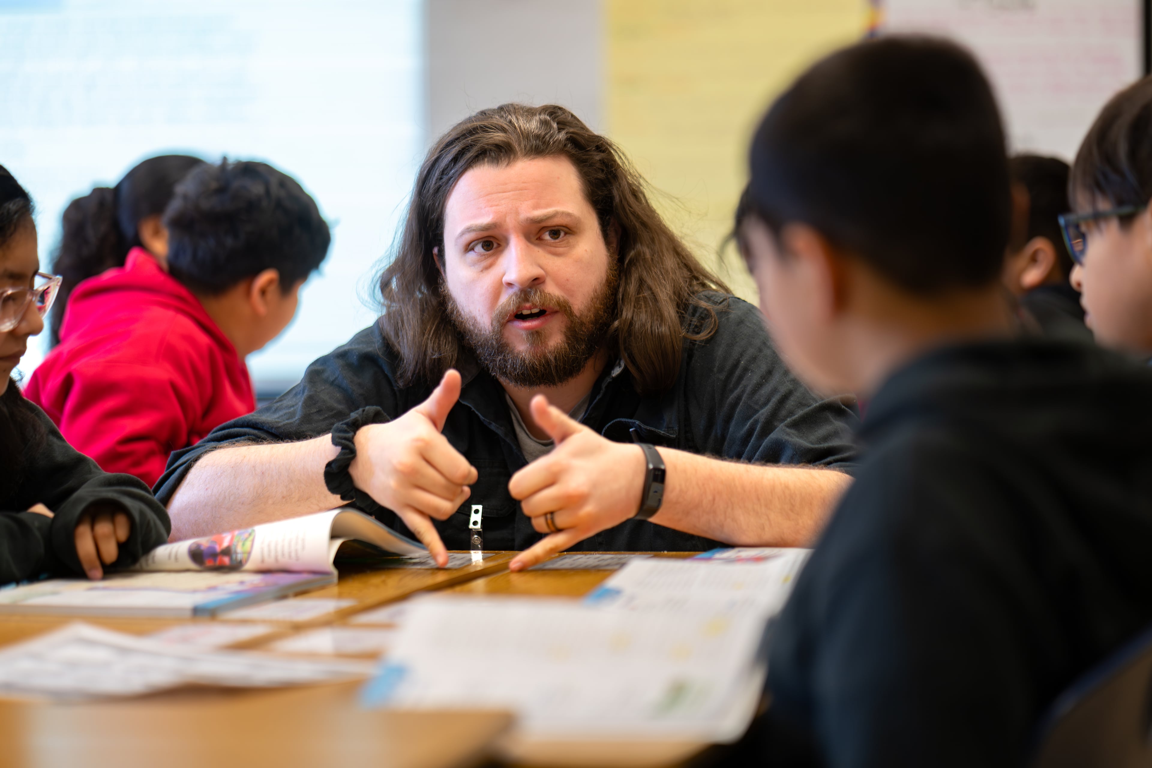 Vickery Mill Elementary School teacher Dylan Townsenger helps his class read and comprehend "Sadie's Game" during a fourth grade group reading class in March. (Ben Hendren for the AJC)