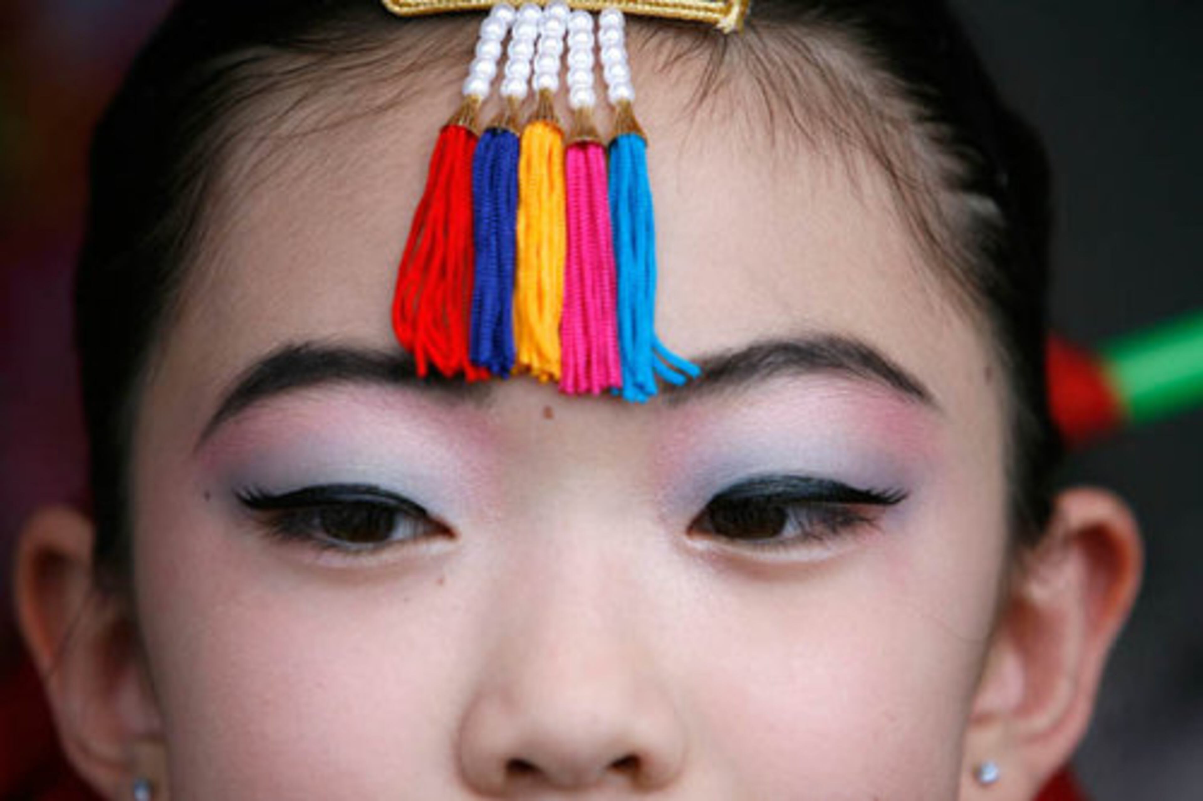 Amanda Kang, 9, is outfitted with the traditional Korean garb called hanbok, before performing "Hwakwannmu" dance.