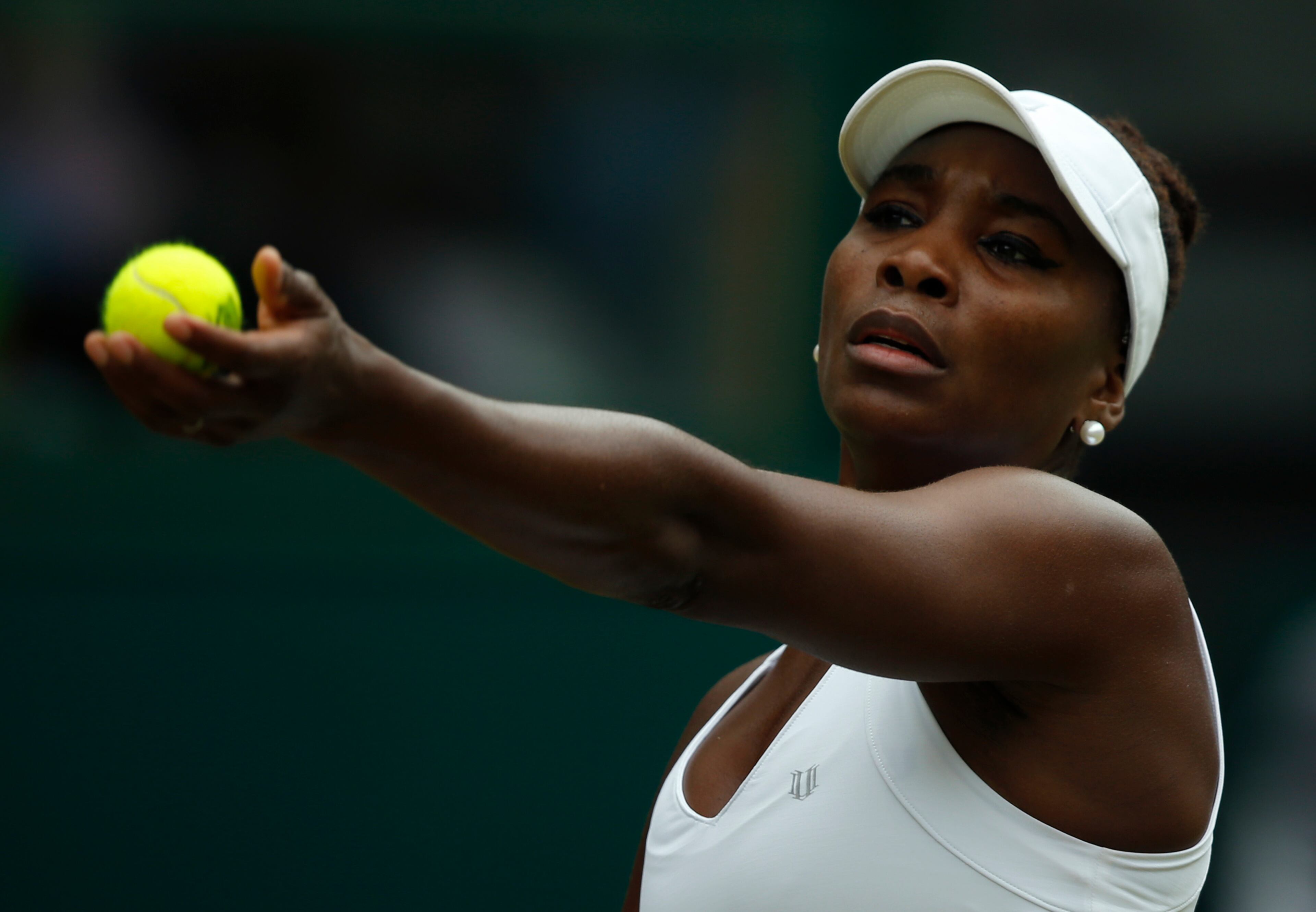 Venus Williams of the United States serves to Serena Williams of the United States, during their singles match against at the All England Lawn Tennis Championships in Wimbledon, London, Monday July 6, 2015. (AP Photo/Alastair Grant)