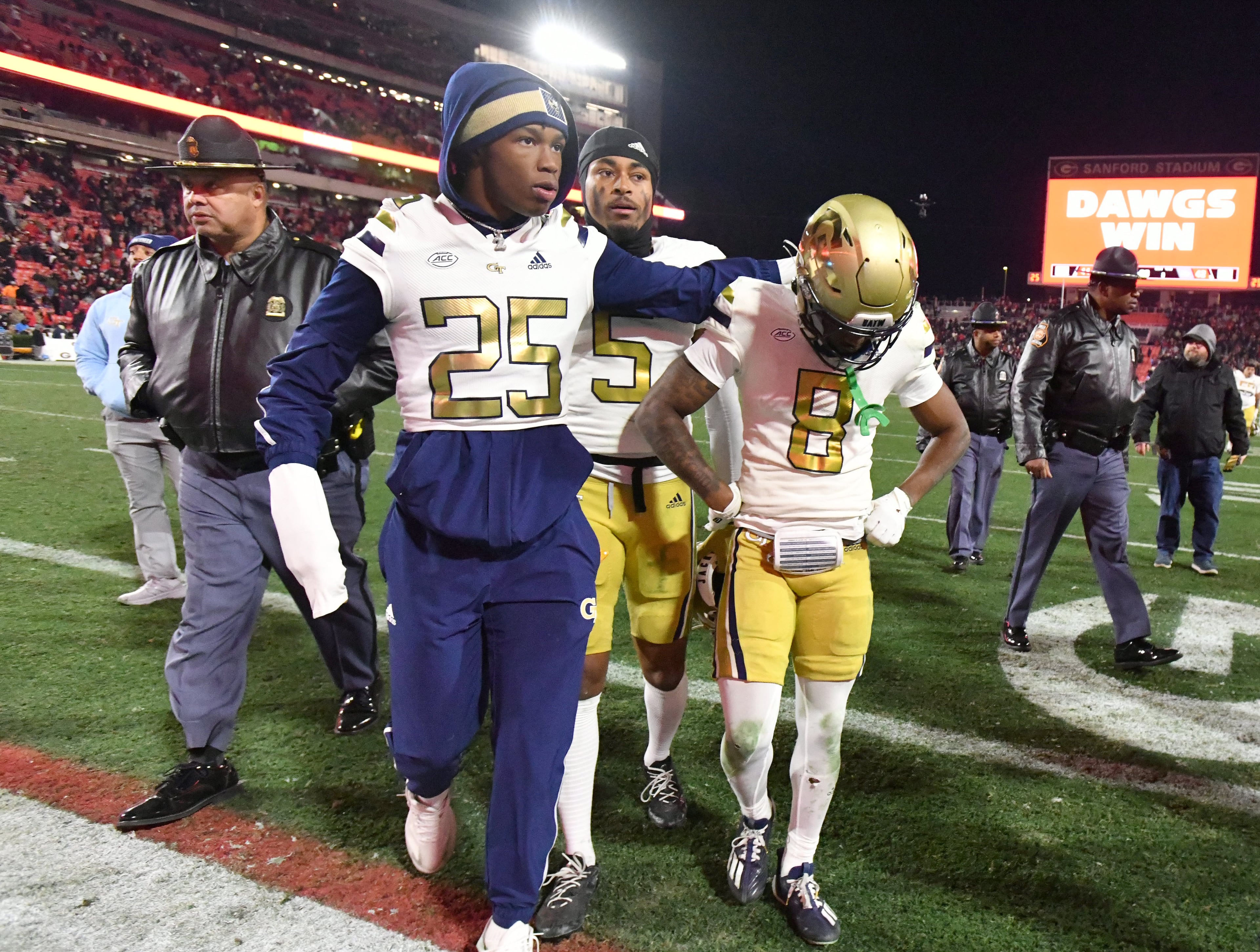 Georgia Tech players leave the football field after Georgia won 44-42 over Georgia Tech in eight overtimes during an NCAA football game at Sanford Stadium, Friday, November 29, 2024, in Athens. (Hyosub Shin / AJC)