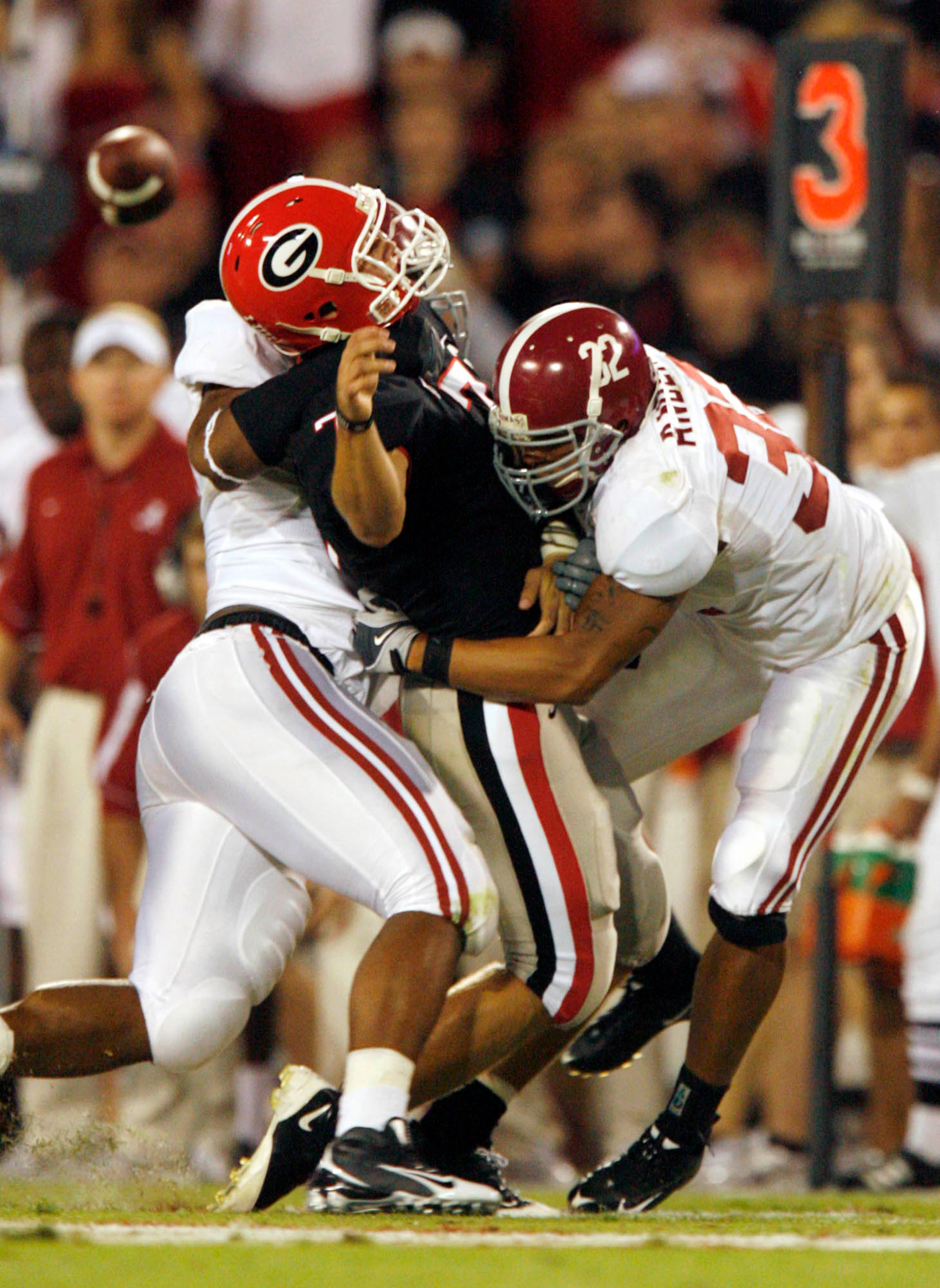 Alabama defensive lineman Lorenzo Washington (97, left) and linebacker Eryk Anders sandwich Georgia quarterback Matthew Stafford in the second quarter of their game at Sanford Stadium on September 27, 2008. Jason Getz / AJC
