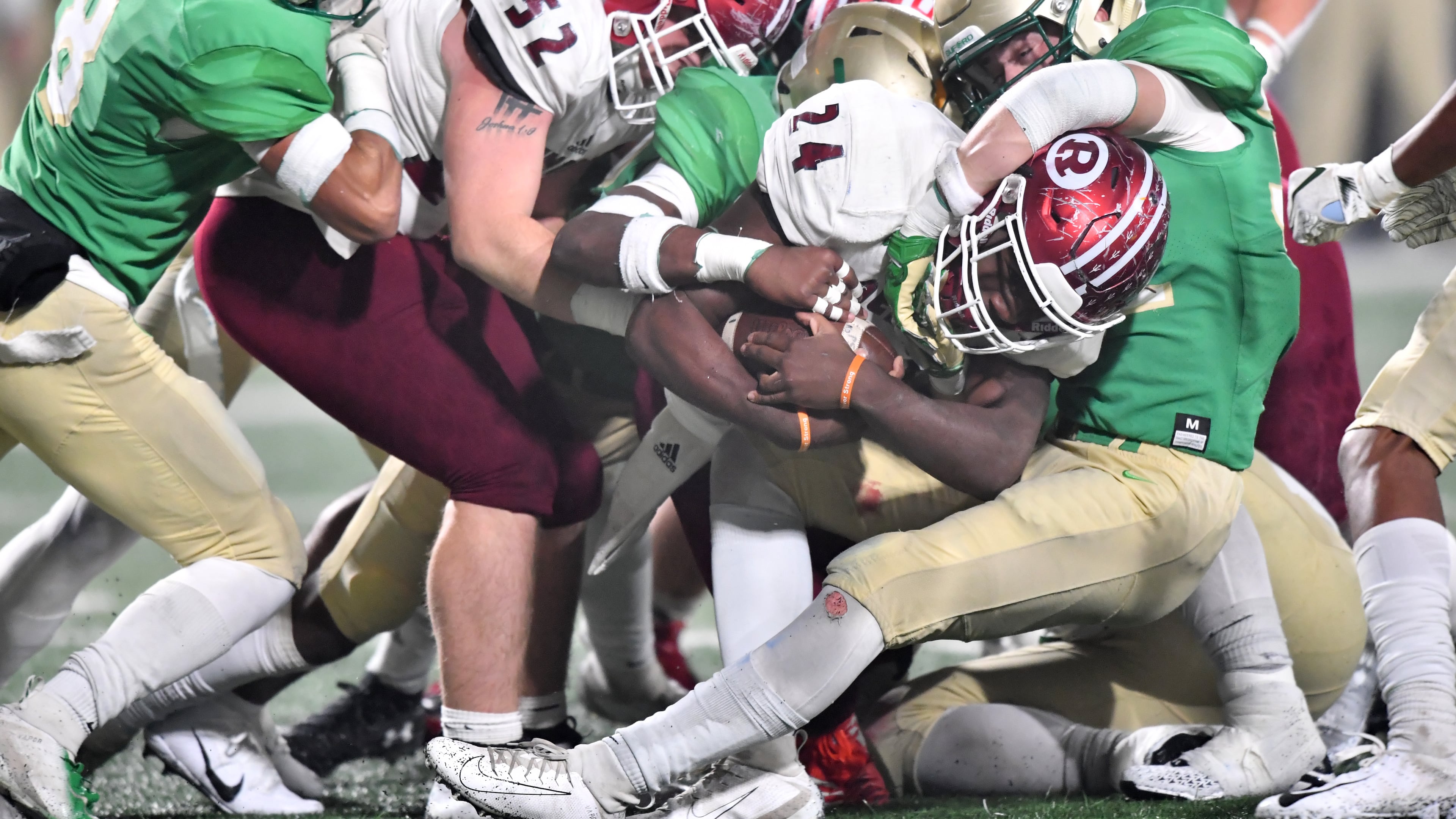 Warner Robins running back Jahlen Rutherford (24) is brought down by Buford's Mason Mccranie (right) in the second half during the GHSA AAAAA state championship game at Georgia State Stadium on Friday, December 13, 2019. Buford won 17-14 over Warner Robins in overtime. (Hyosub Shin / Hyosub.Shin@ajc.com)