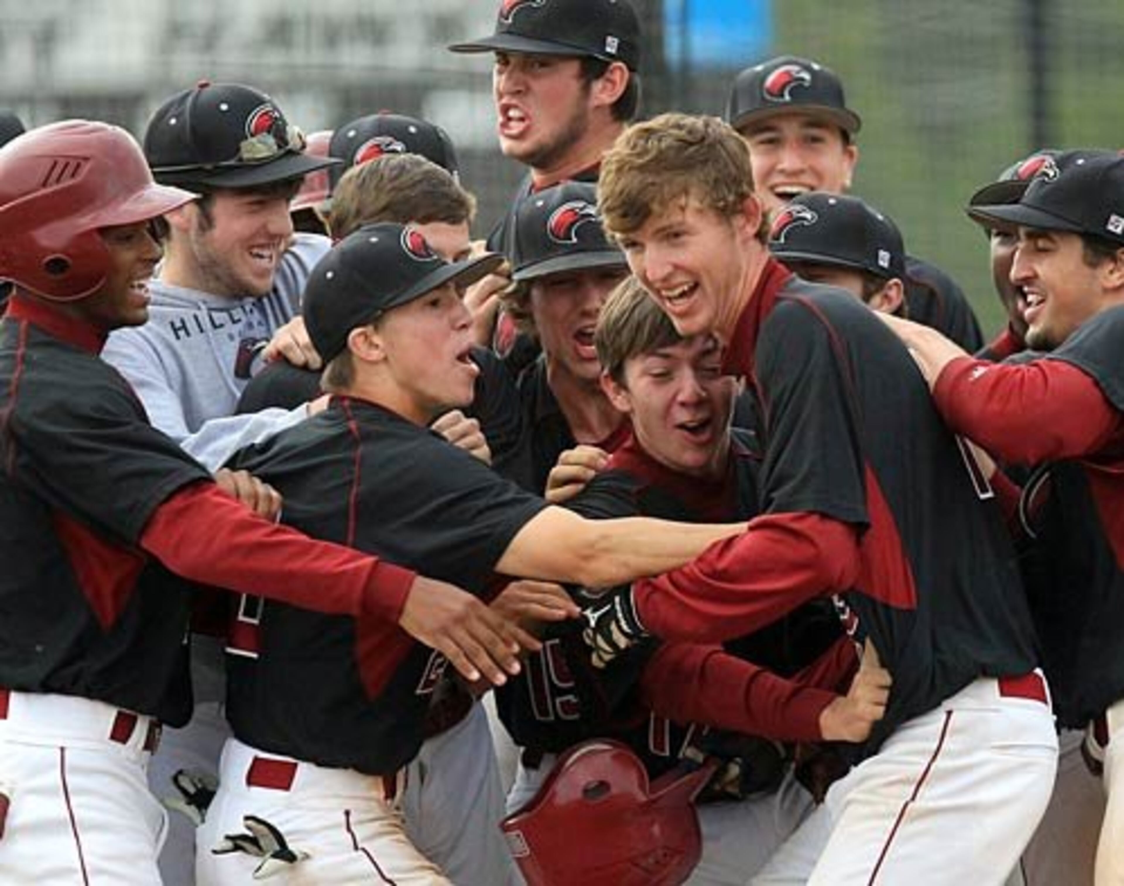 Gimme five: Hillgrove's Max Oberkofler, right, is all smiles as he is mobbed by teammates at home plate after hitting a two-RBI homer to cap a five-run comeback in the 5th inning that tied the game 5-5 with Mill Creek.