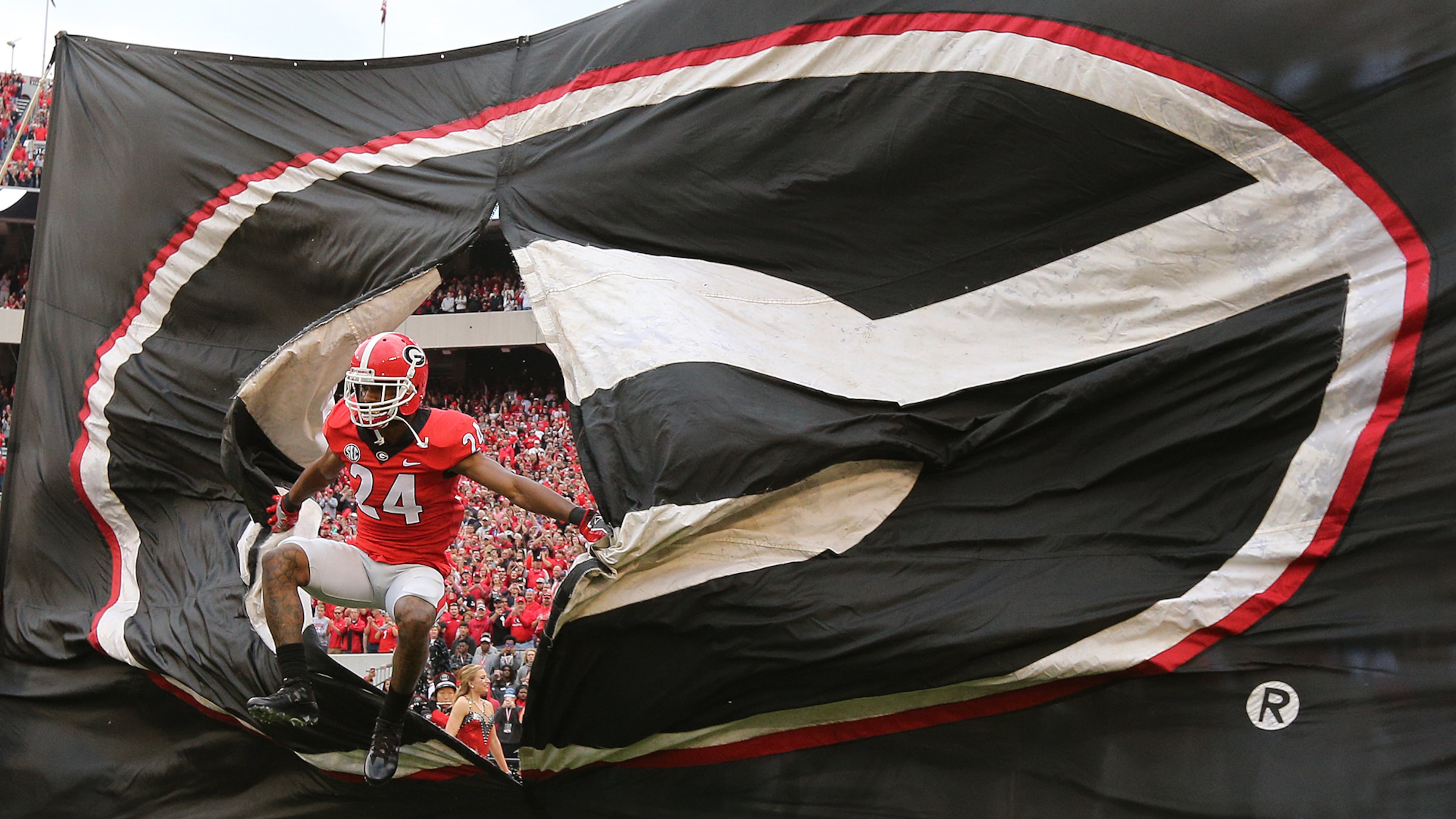 Georgia senior safety Dominick Sanders leads the team through the G to take on Kentucky in a NCAA college football game on Saturday, November 18, 2017, in Athens. Curtis Compton/ccompton@ajc.com