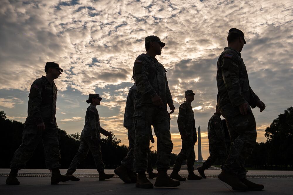 Members of the National Guard walk past the Lincoln Memorial Reflecting Pool before the March on Washington last month. (Julia Demaree Nikhinson/AP)