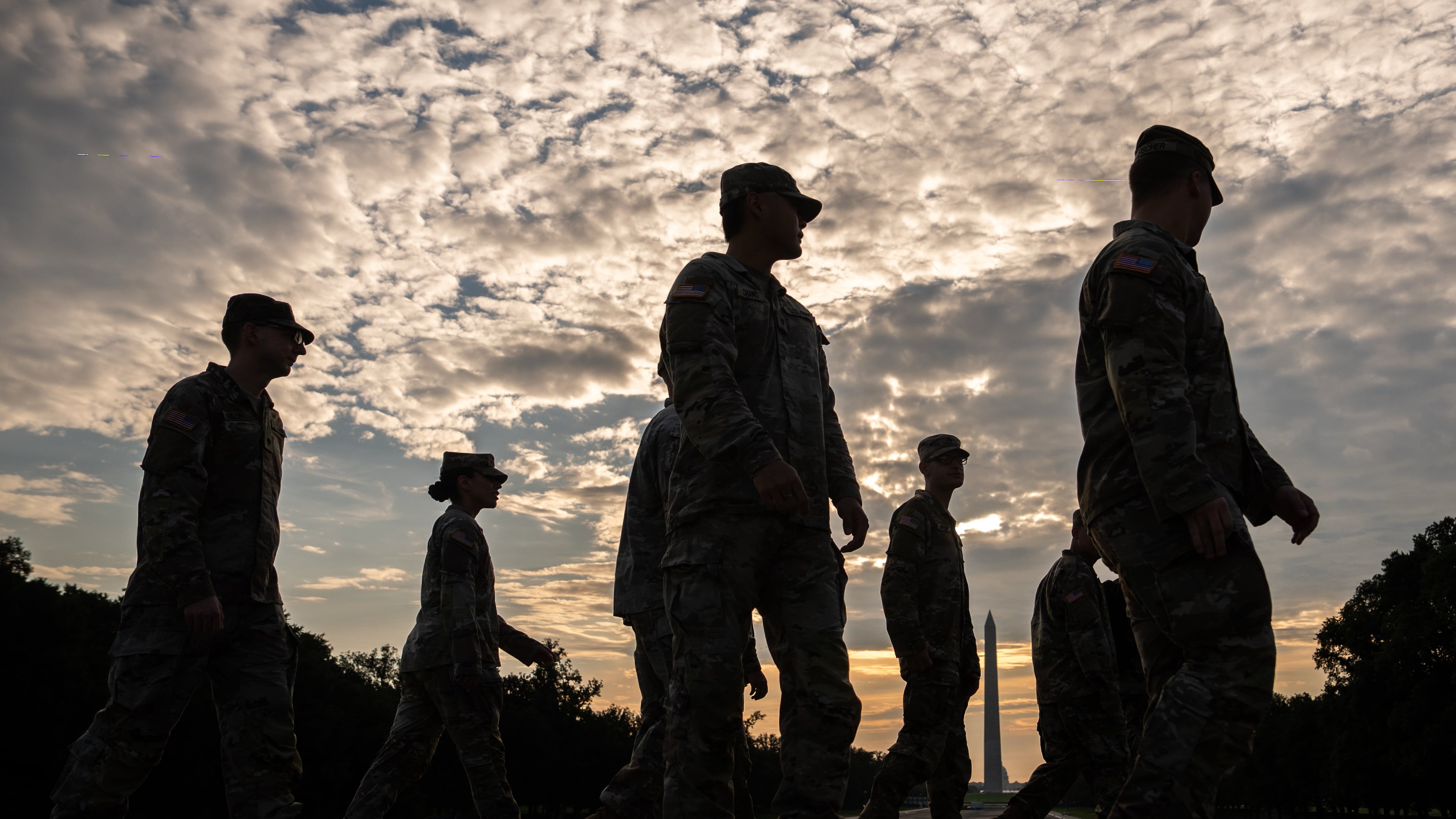 Members of the National Guard walk past the Lincoln Memorial Reflecting Pool before the March on Washington, Friday, Aug. 28, 2026, in Washington. (Julia Demaree Nikhinson/AP)