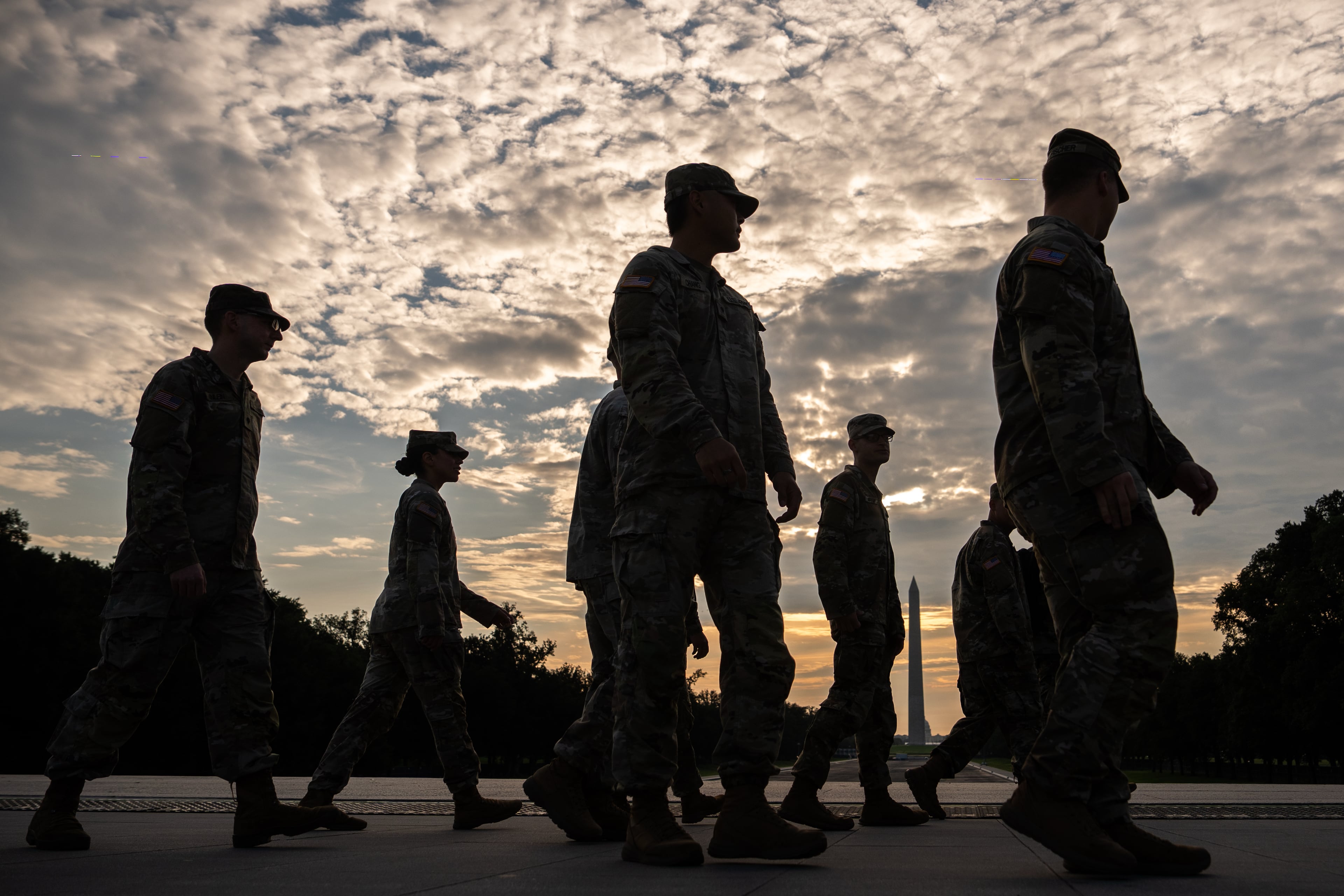 Members of the National Guard walk past the Lincoln Memorial Reflecting Pool before the March on Washington, Friday, Aug. 28, 2026, in Washington. (Julia Demaree Nikhinson/AP)