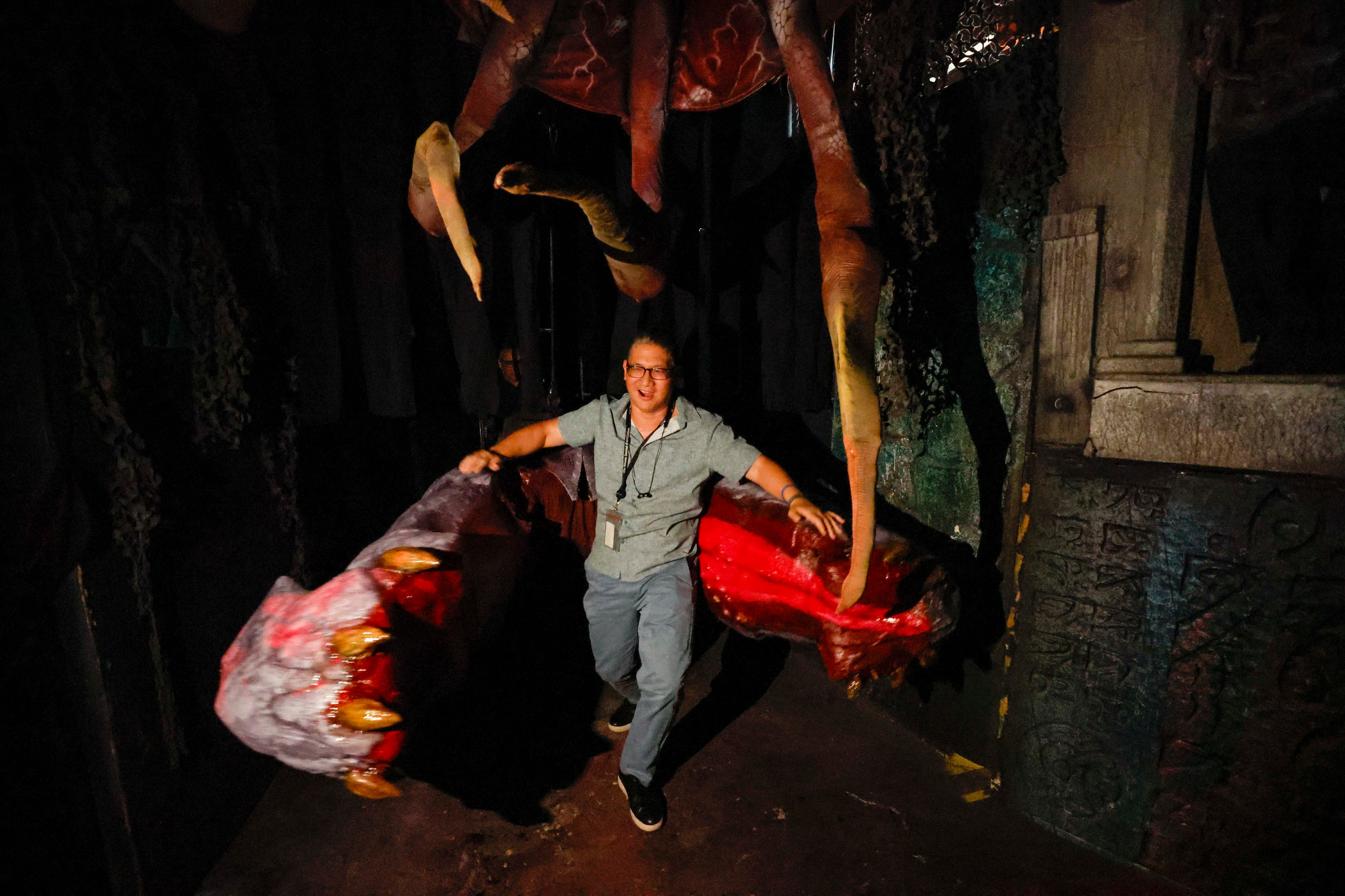 AJC Entertainment’s Rodney Ho gets trapped by a monster as he tours Netherworld in Stone Mountain, Atlanta, on Thursday, Sept. 10, 2026, alongside hundreds of animatronics, special effects and props. The haunted house begins its 30th season. Netherworld runs two haunted attractions within a 70,000-square-foot warehouse and employs approximately 500 staff each season. (Miguel Martinez/AJC)