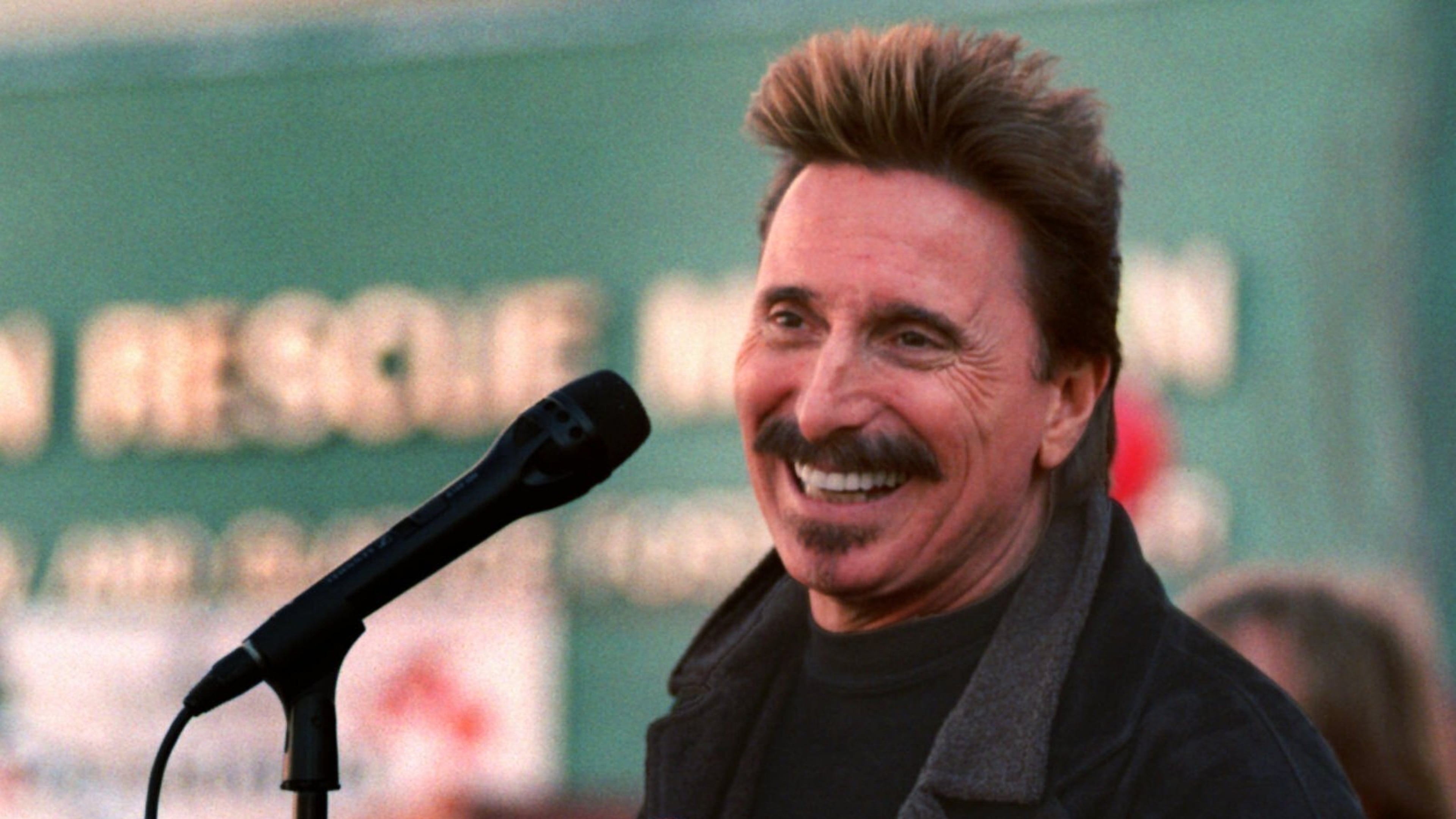 FILE - Chuck Negron, former lead singer of Three Dog Night, sings to a crowd during a Christmas Eve party, Dec. 24, 1997, at the Union Rescue Mission in Los Angeles. (AP Photo/John Hayes, File)