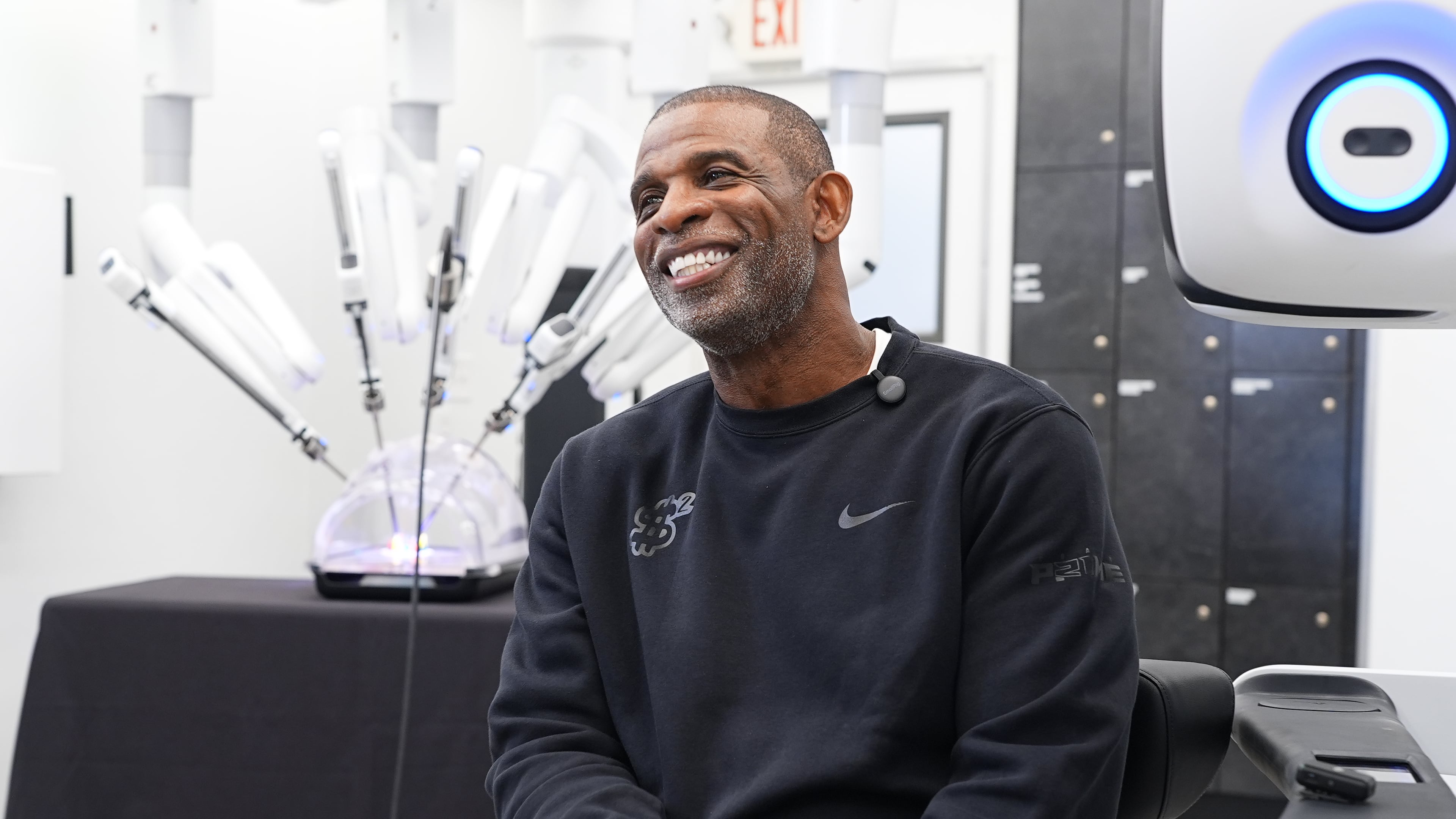 Colorado head football coach Deion Sanders talks about working the Da Vinci robotic surgical machine used to remove his cancerous bladder last year during a demonstration of the device Tuesday, June 23, 2026, in Boulder, Colo. (AP Photo/David Zalubowski)
