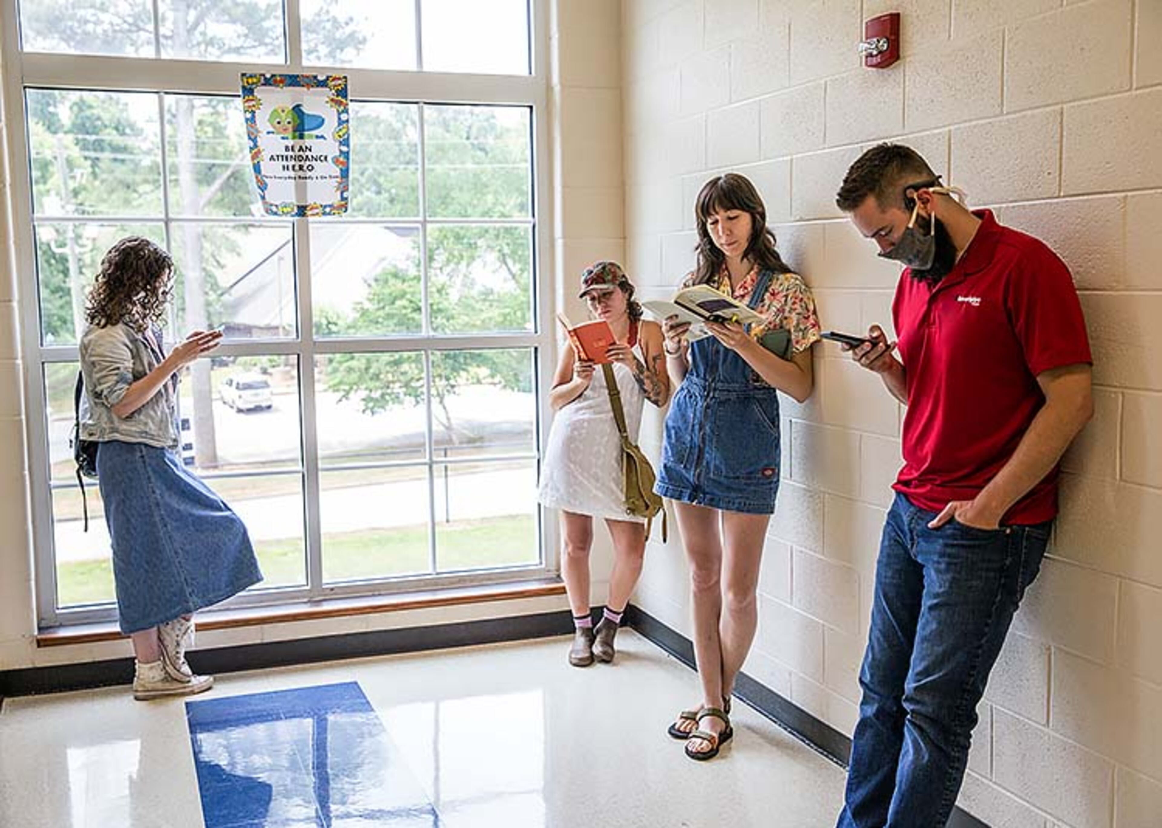 Voters wait in long lines at Peachcrest Elementary School on Tuesday, June 9, 2020. The gym only has five voting machines set up despite having nine others onsite. The Covid-19 restrictions only allow 10 people in the gym at a time so many machines are not being used, creating long wait times. The lines around lunchtime were taking 2.5 hours. (Jenni Girtman for The Atlanta Journal-Constitution)