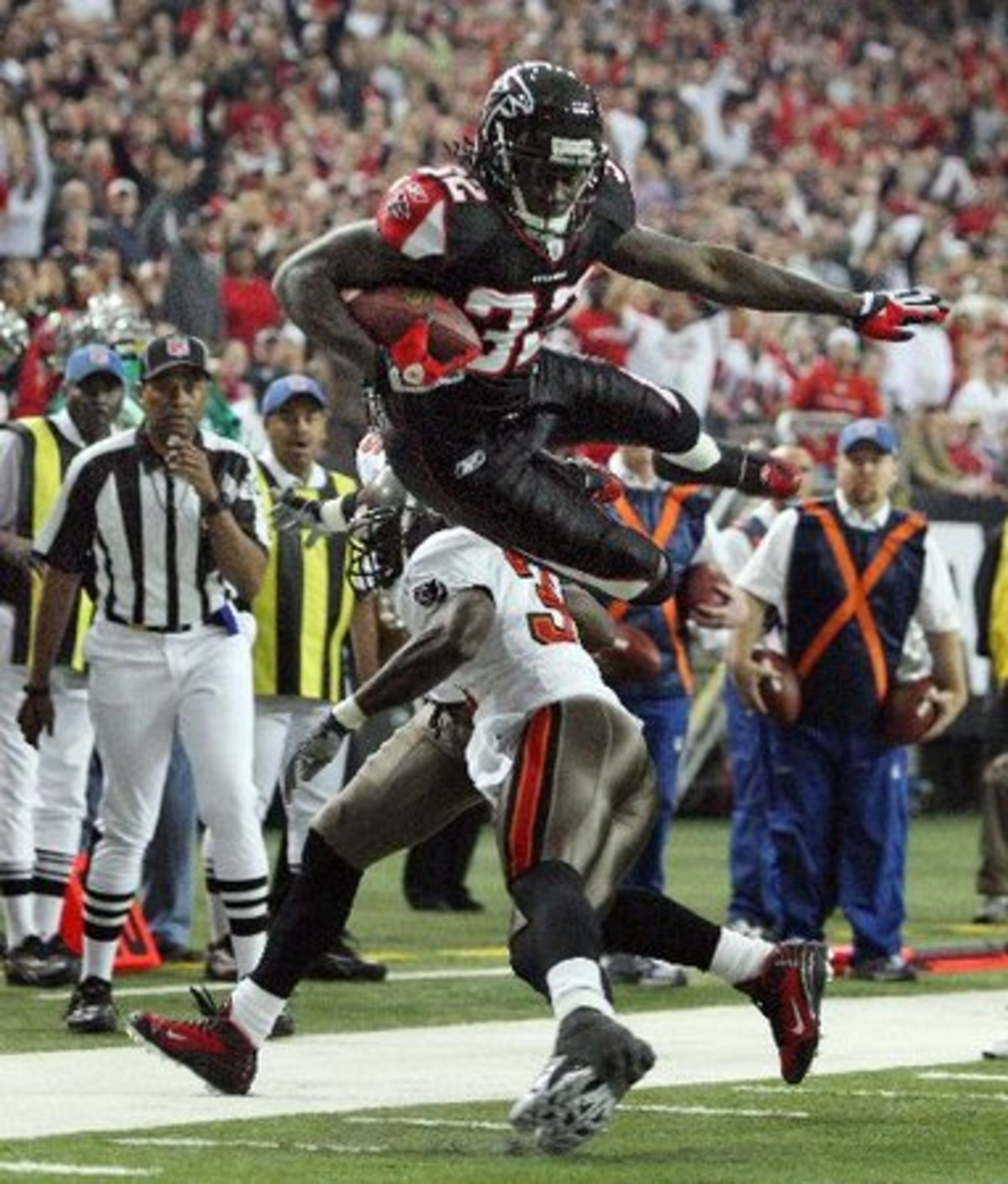 With Atlanta ahead 3-0 in the firt quarter, Falcons running back Jerious Norwood is upended by Tampa Bay's Phillip Buchanon near the goal line.
