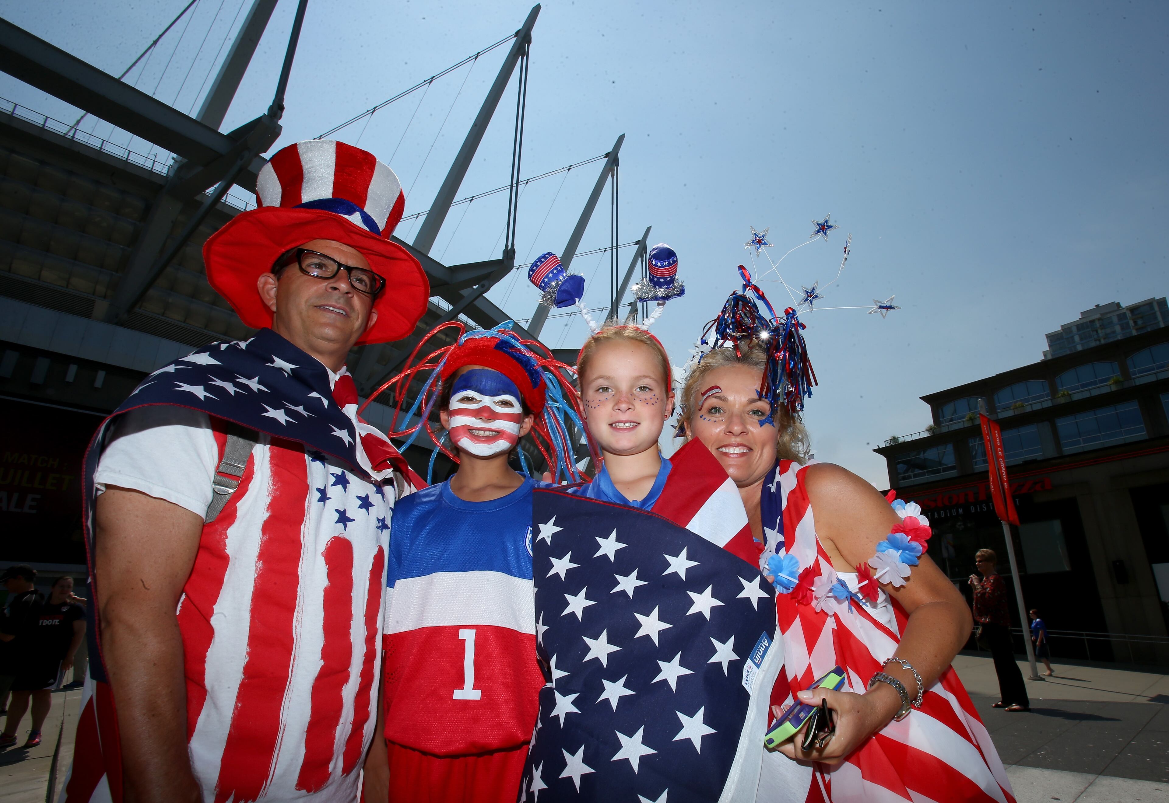 VANCOUVER, BC - JULY 05: Fans of the United States pose outside BC Place Stadium before the USA takes on Japan in the FIFA Women's World Cup Canada 2015 Final on July 5, 2015 in Vancouver, Canada. (Photo by Ronald Martinez/Getty Images)
