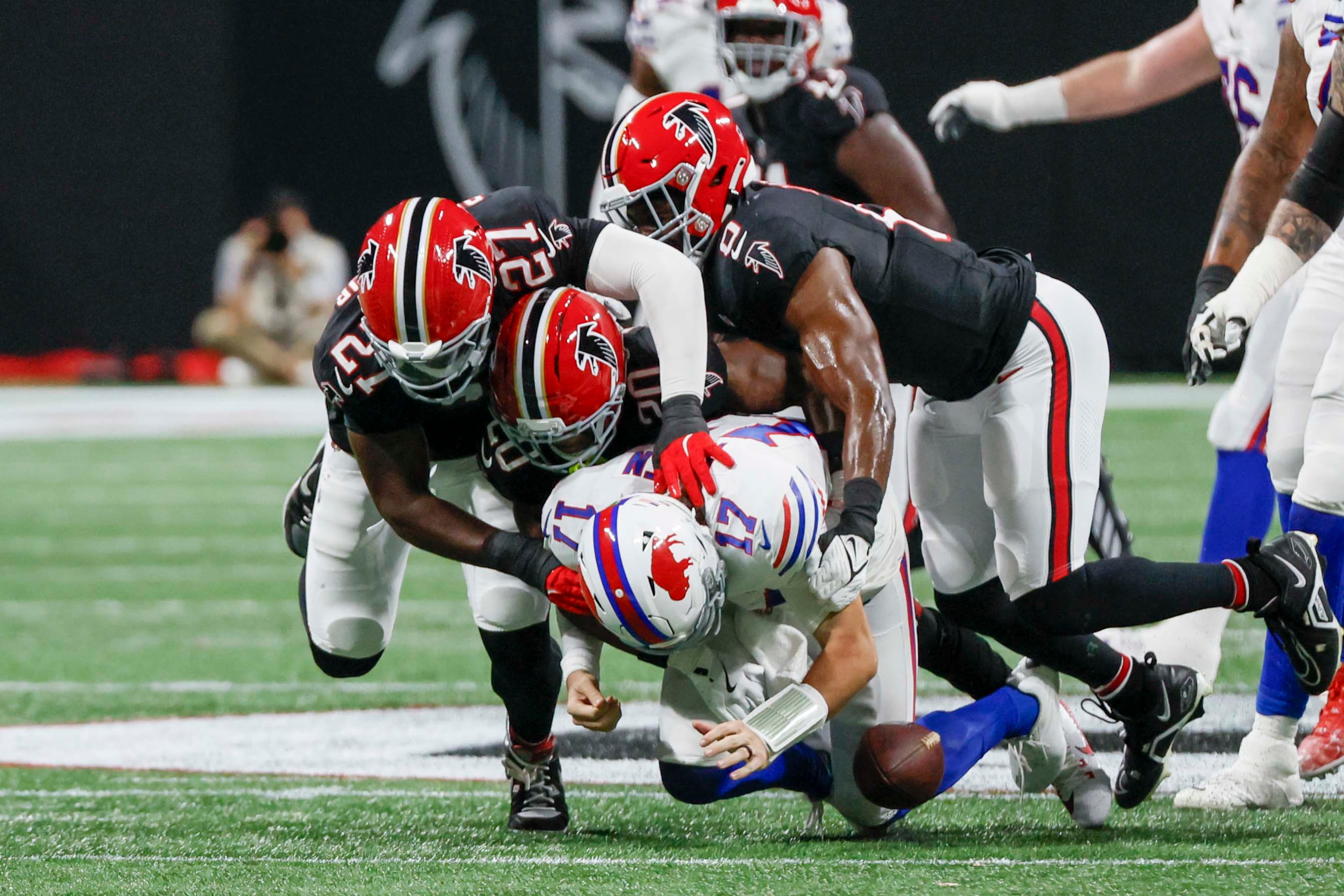 Falcons linebacker Divine Deablo (right), Atlanta Falcons cornerback Dee Alford (middle) and Atlanta Falcons defensive end James Pearce Jr. (left) grab Buffalo Bills quarterback Josh Allen for a sack during the first half of an NFL football game against the Buffalo Bills at Mercedes-Benz Stadium in Atlanta on Monday, October 13, 2025. (Miguel Martinez/AJC)