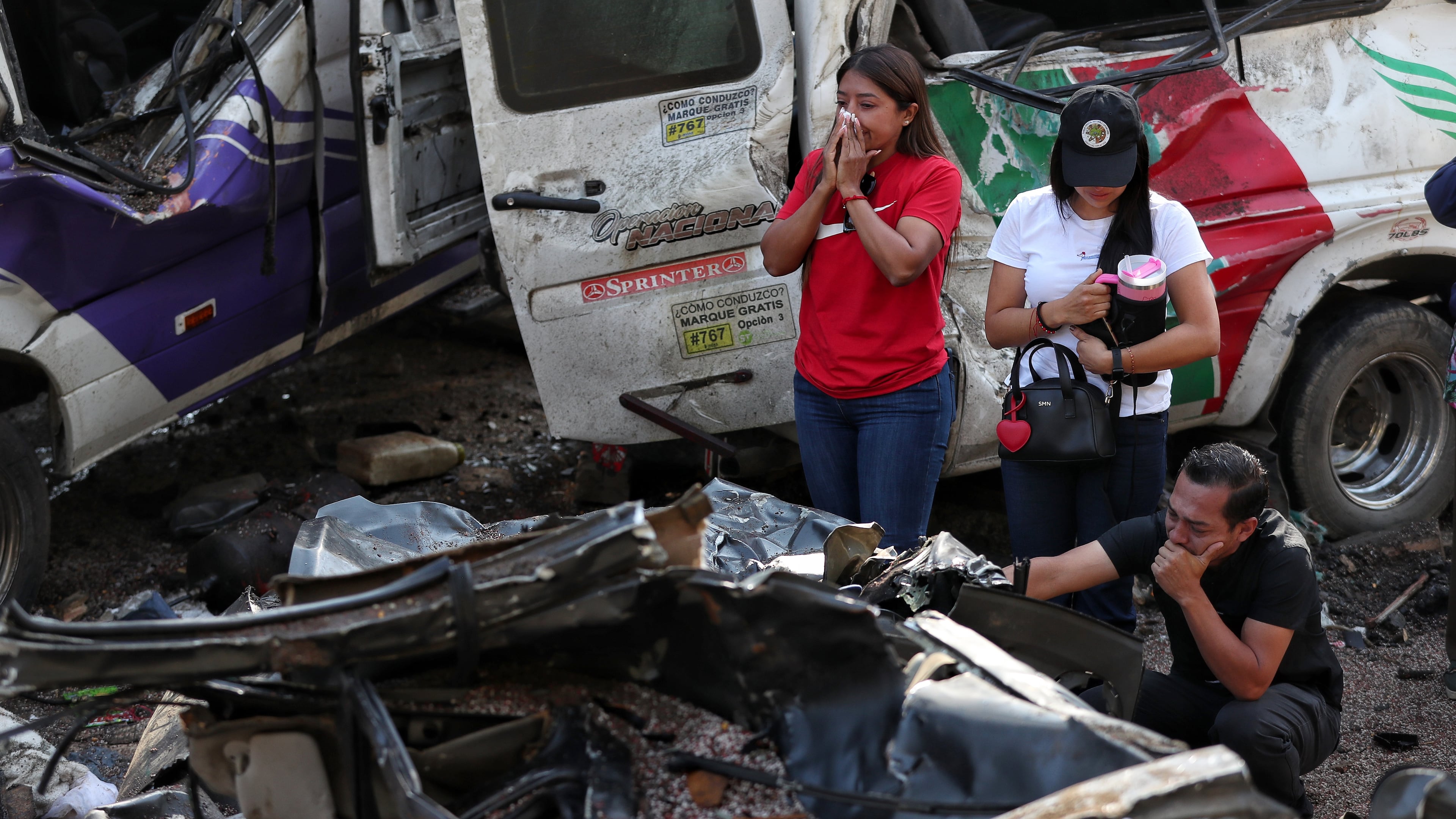 Relatives of victims pay respects at the site of an attack on the Pan-American Highway in Cajibio, Colombia, Sunday, April 26, 2026, where at least a dozen people were killed in an attack authorities blamed on dissident groups of the former FARC rebels. (AP Photo/Santiago Saldarriaga)