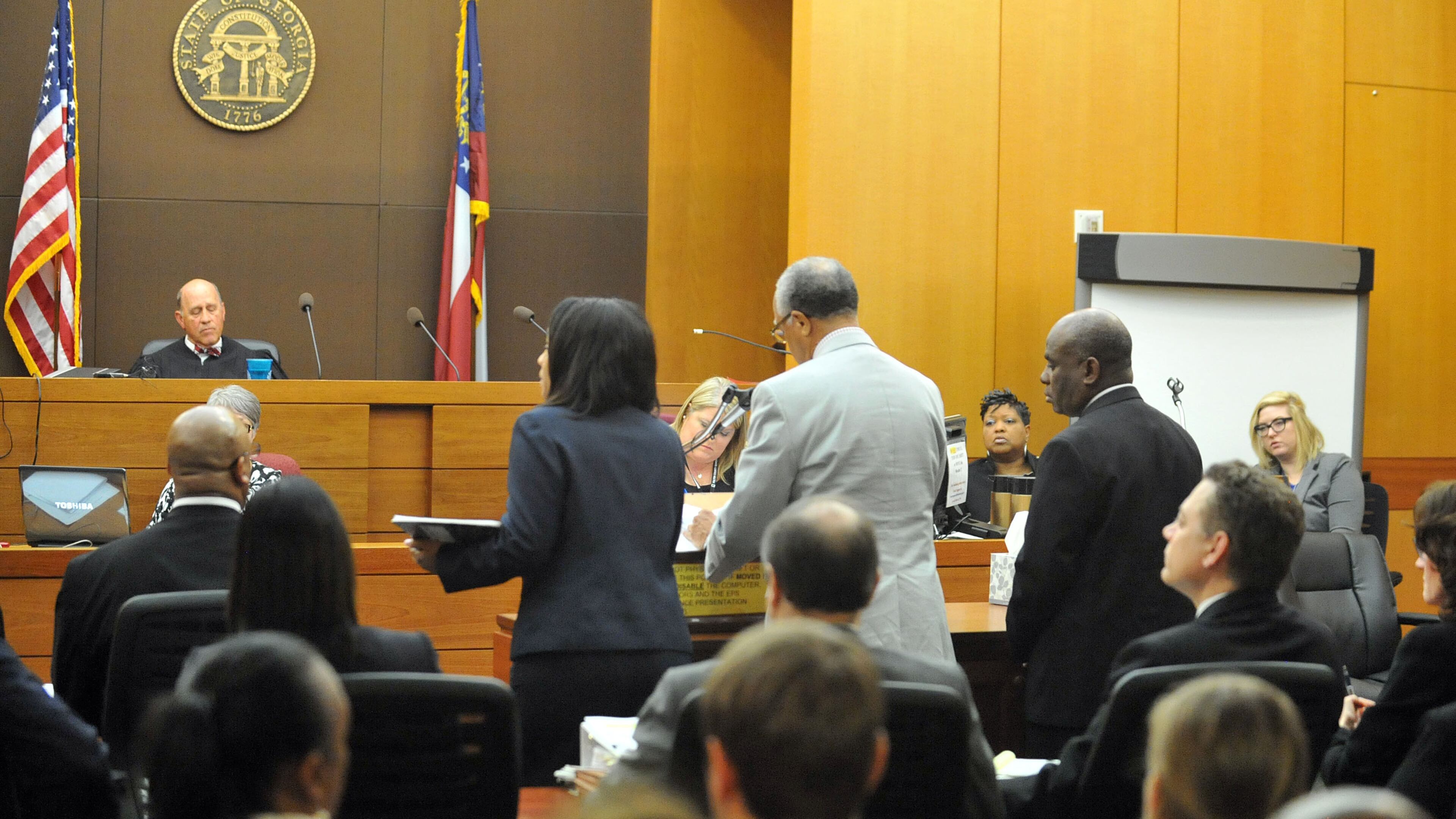 APRIL 14, 2015 ATLANTA Former APS Usher Collier Heights Elem testing coordinator Donald Bullock (right) stands as his defense attorney Hurl Taylor accepts a sentencing deal for 5 years probation, 6 months of weekends in jail, $5000 fine and 1500 hours of community service. Sentencing continues for 10 of the 11 defendants convicted of racketeering and other charges in the Atlanta Public Schools test-cheating trial before Judge Jerry Baxter in Fulton County Superior Court, Tuesday, April 14, 2015. (Atlanta Journal-Constitution, Kent D. Johnson, Pool)