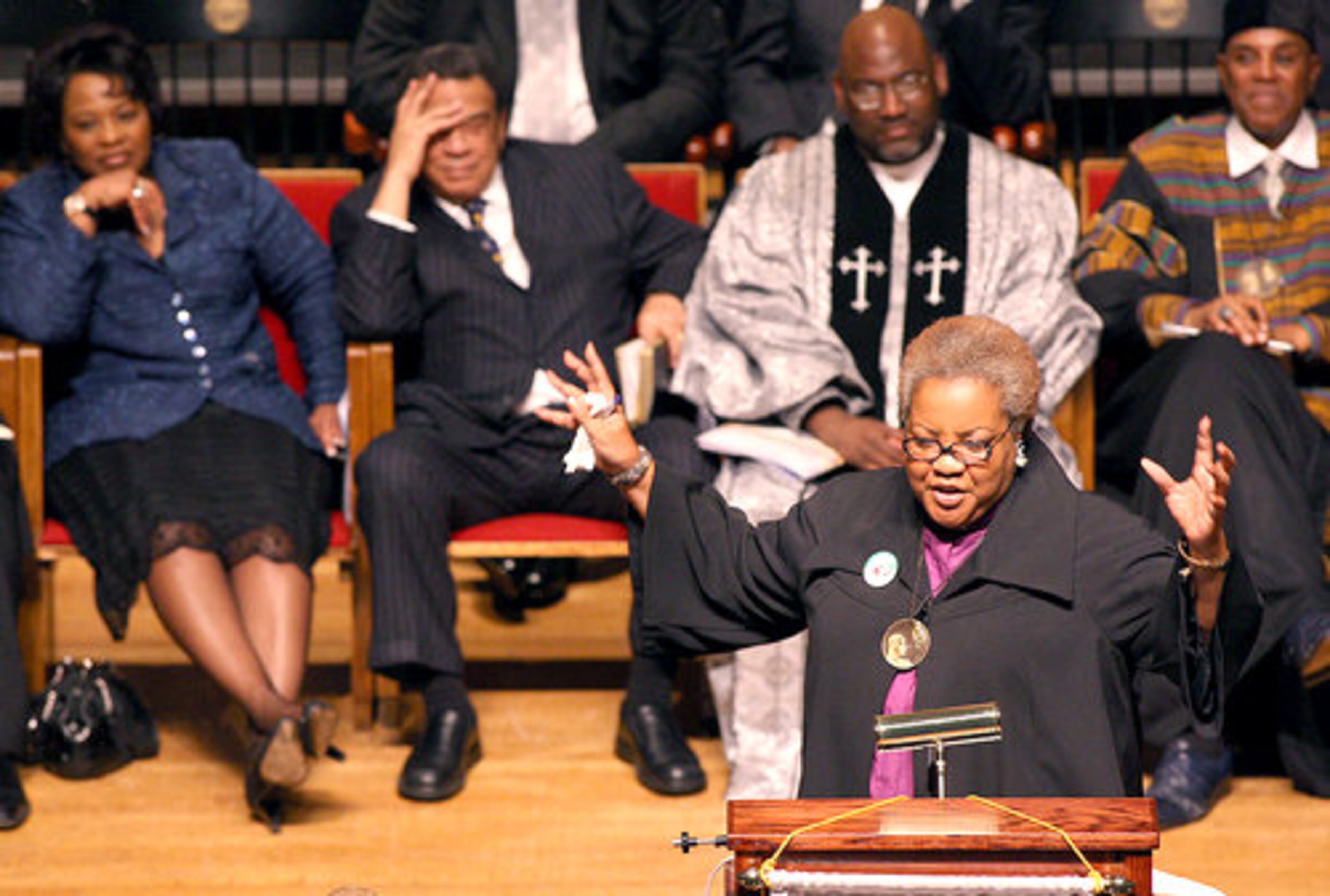 Elizabeth Omilami, of Hosea Feed the Hungry, speaks during the service.