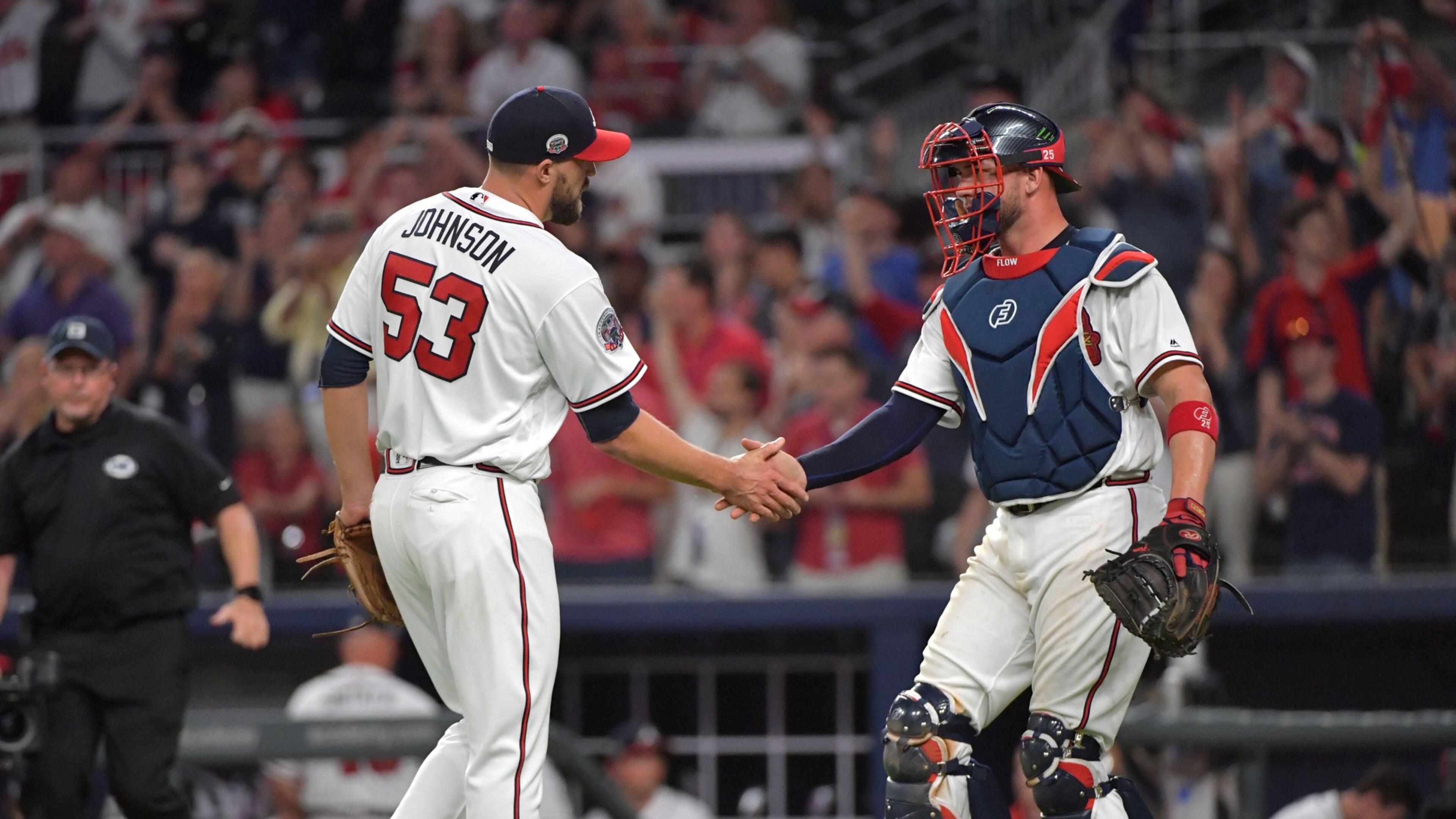 Braves closer Jim Johnson catcher Tyler Flowers shake hands after the Braves home-opening win Friday against the Padres. (HYOSUB SHIN / HSHIN@AJC.COM)