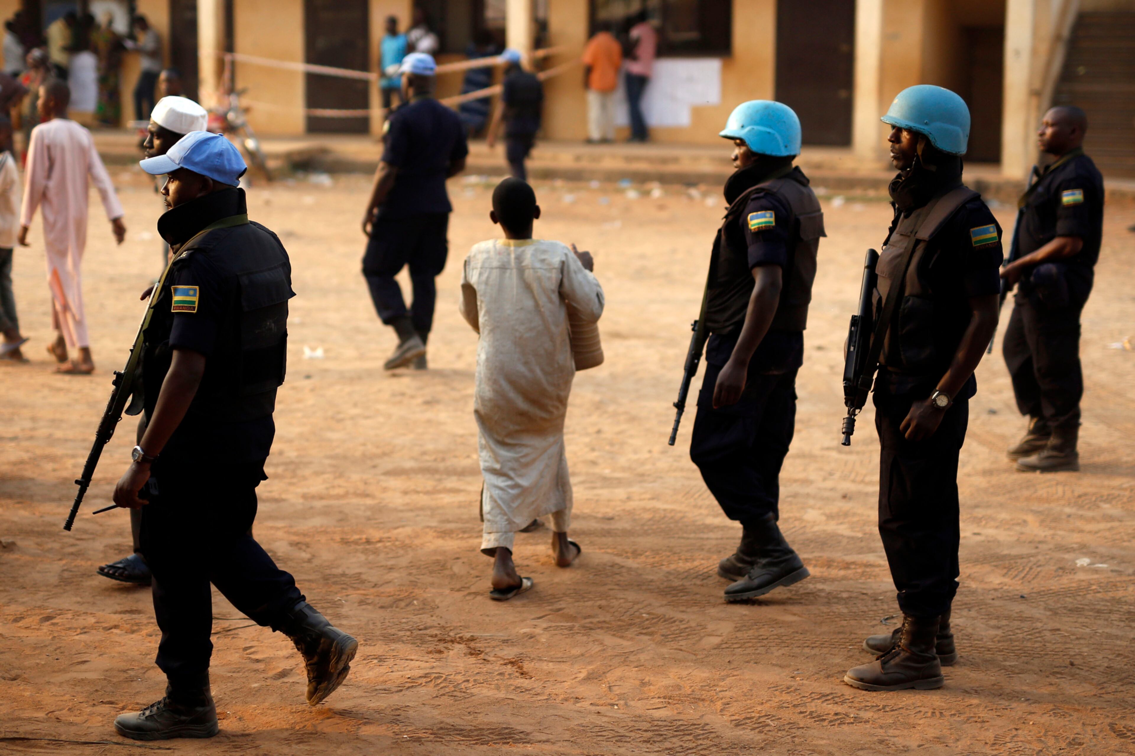 VOTING PATROL--UN peacekeepers from Rwanda secure a polling station during vote counting in Bangui, Central African Republic, Sunday Feb. 14, 2016. Two former prime ministers, Faustin Archange Touadera and Anicet Georges Dologuele, are running neck-and-neck in the second round of presidential elections to end years of violence pitting Muslims against Christians in the Central African Republic. Central Africans will also vote in legislative elections. (AP Photo/Jerome Delay)