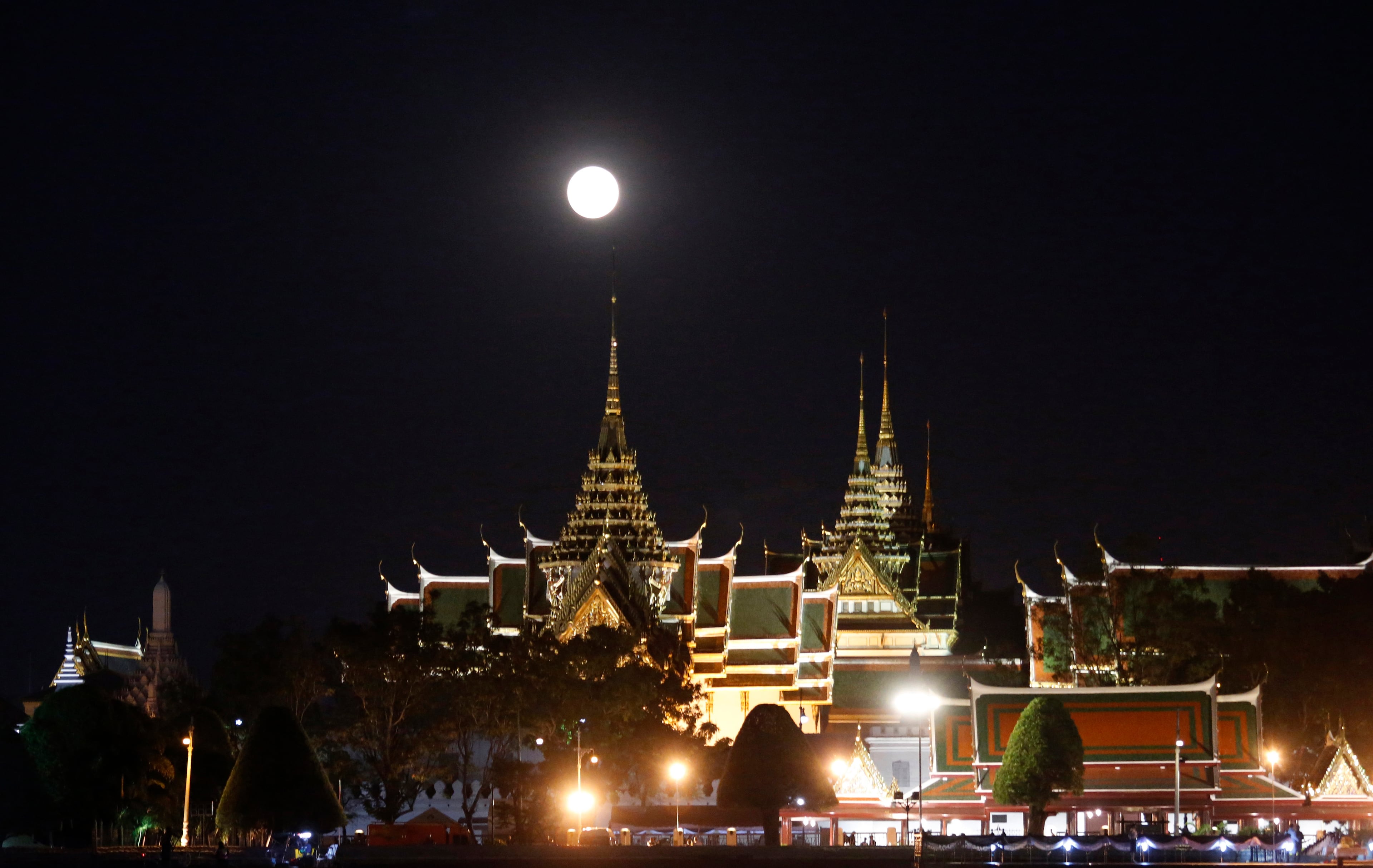 The moon rises over the Grand Palace in Bangkok, Thailand Monday, Nov. 14, 2016. The brightest moon in almost 69 years lights up the sky this week in a treat for star watchers around the globe. The phenomenon is known as the supermoon. (AP Photo/Sakchai Lalit)