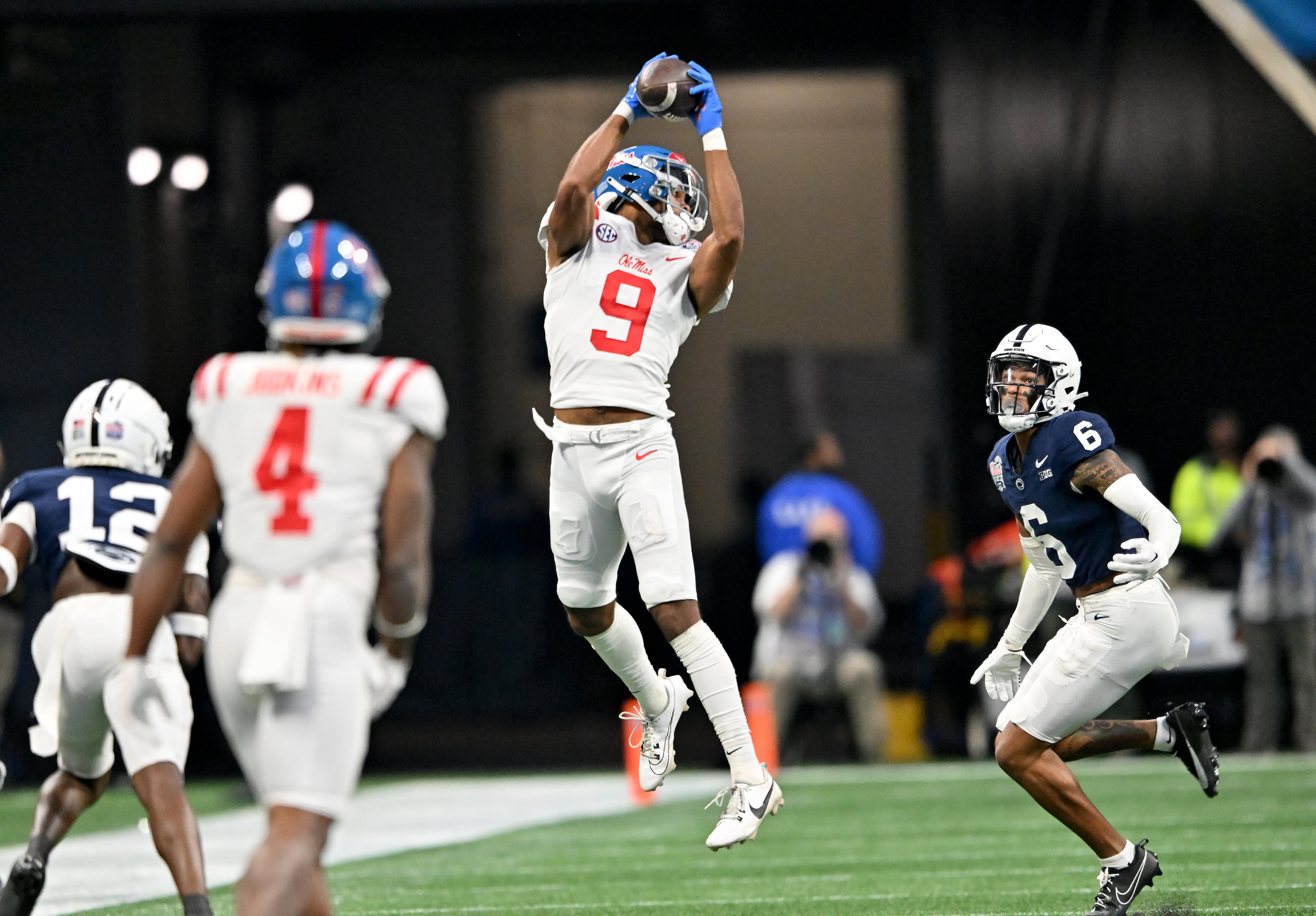 Ole Miss wide receiver Tre Harris (9) makes a catch over Penn State safety Zakee Wheatley (6) during the first half in 2023 Chick-fil-A Peach Bowl at Mercedes-Benz Stadium, Saturday, December 30, 2023, in Atlanta. (Hyosub Shin / Hyosub.Shin@ajc.com)