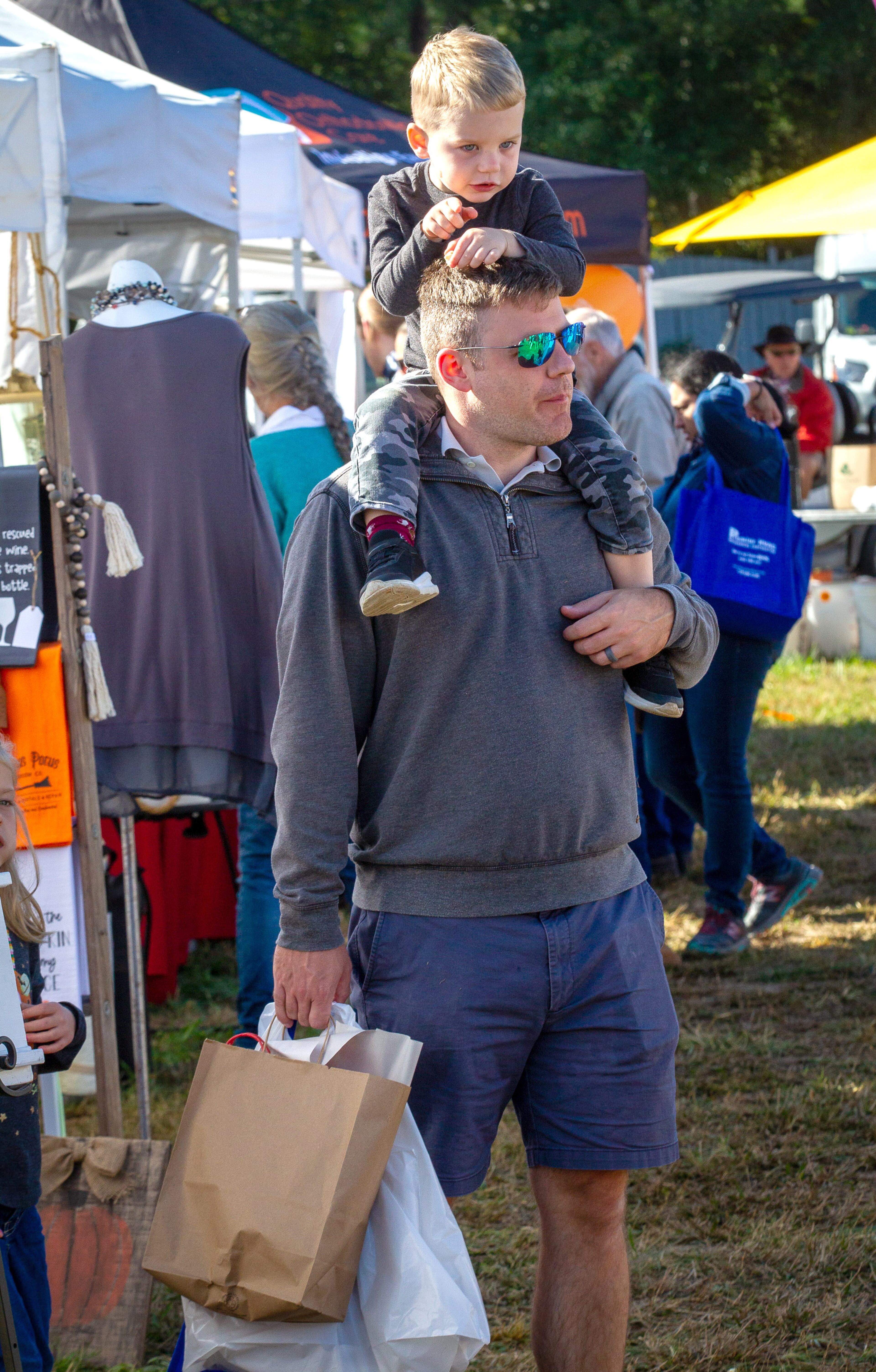 Tyler Hein and his son Calix, 3, look over the artists' tents at the Johns Creek Arts Festival on Sunday, October 17, 2021. (Photo: Steve Schaefer for The Atlanta Journal-Constitution)