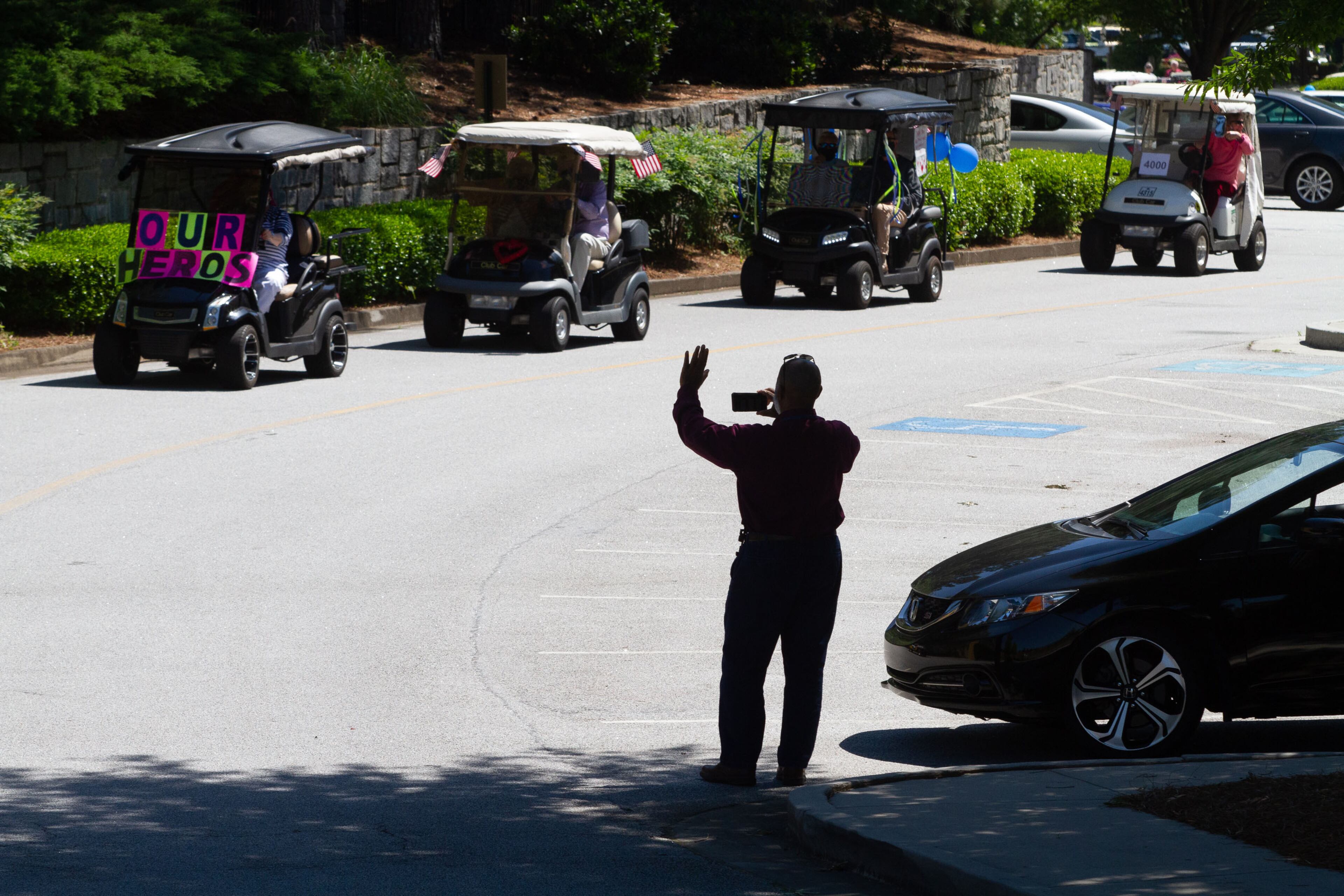 Park Springs independent living residents staged a golf cart parade on Sunday, May 10, 2020, to thank all the staff members who have voluntarily remained on the senior community Stone Mountain campus since March 30 during the coronavirus pandemic. STEVE SCHAEFER / SPECIAL TO THE AJC