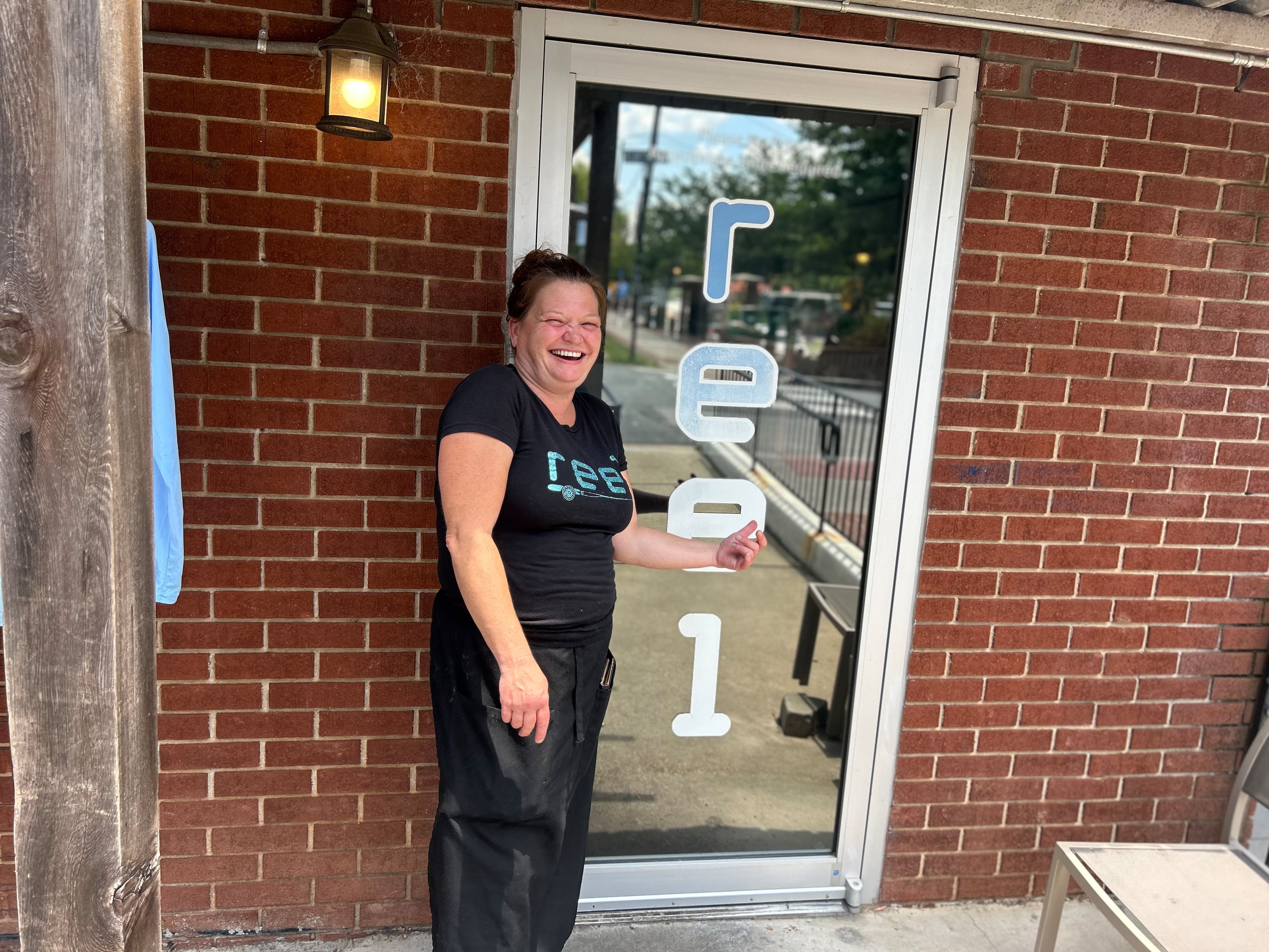 Staci Wright, a manager at Reel Seafood, said it "doesn’t make any sense" that she and other employees in downtown Woodstock will now have to pay to work. (Gray Mollenkamp/AJC)