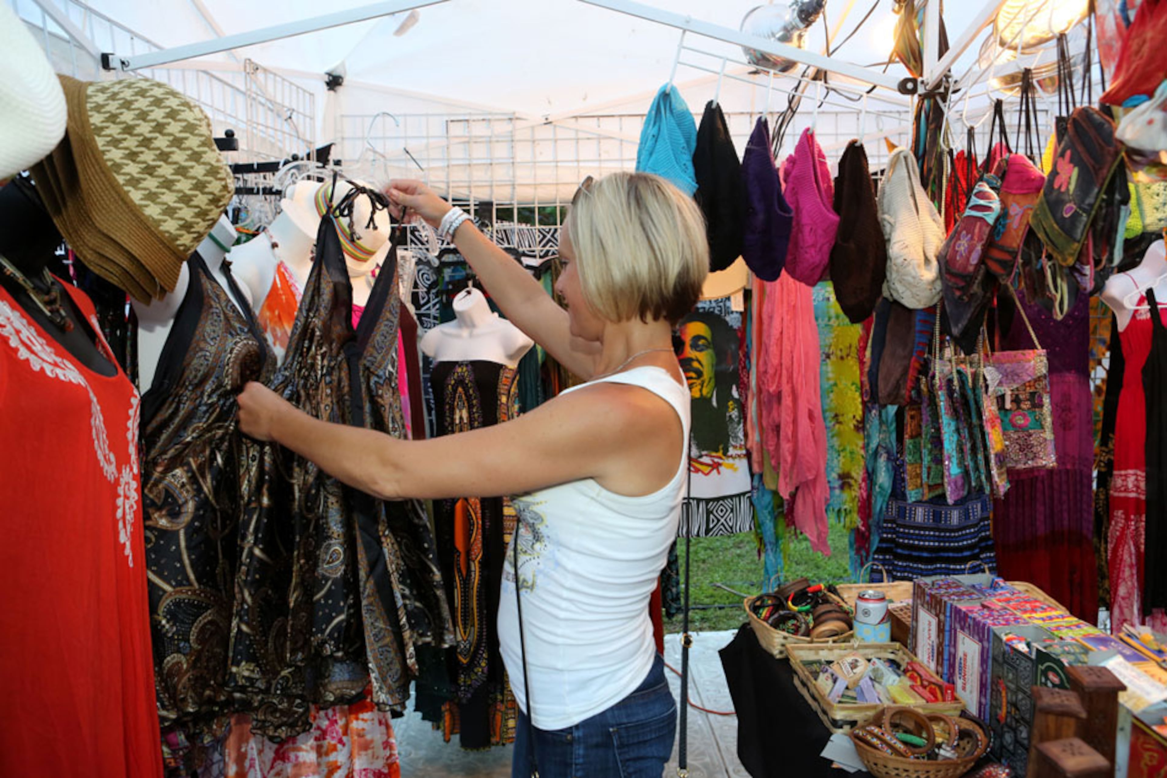 Jeni Pekala of Brookhaven checks out some of the clothing selections in the vendor area. The Drive-By Truckers and Shovels & Rope headlined the second day of the Candler Park Music and Food Festival in Atlanta on Saturday, May 30, 2015 with a capacity crowd in excess of 15,000. Robb D. Cohen/RobbsPhotos.com
