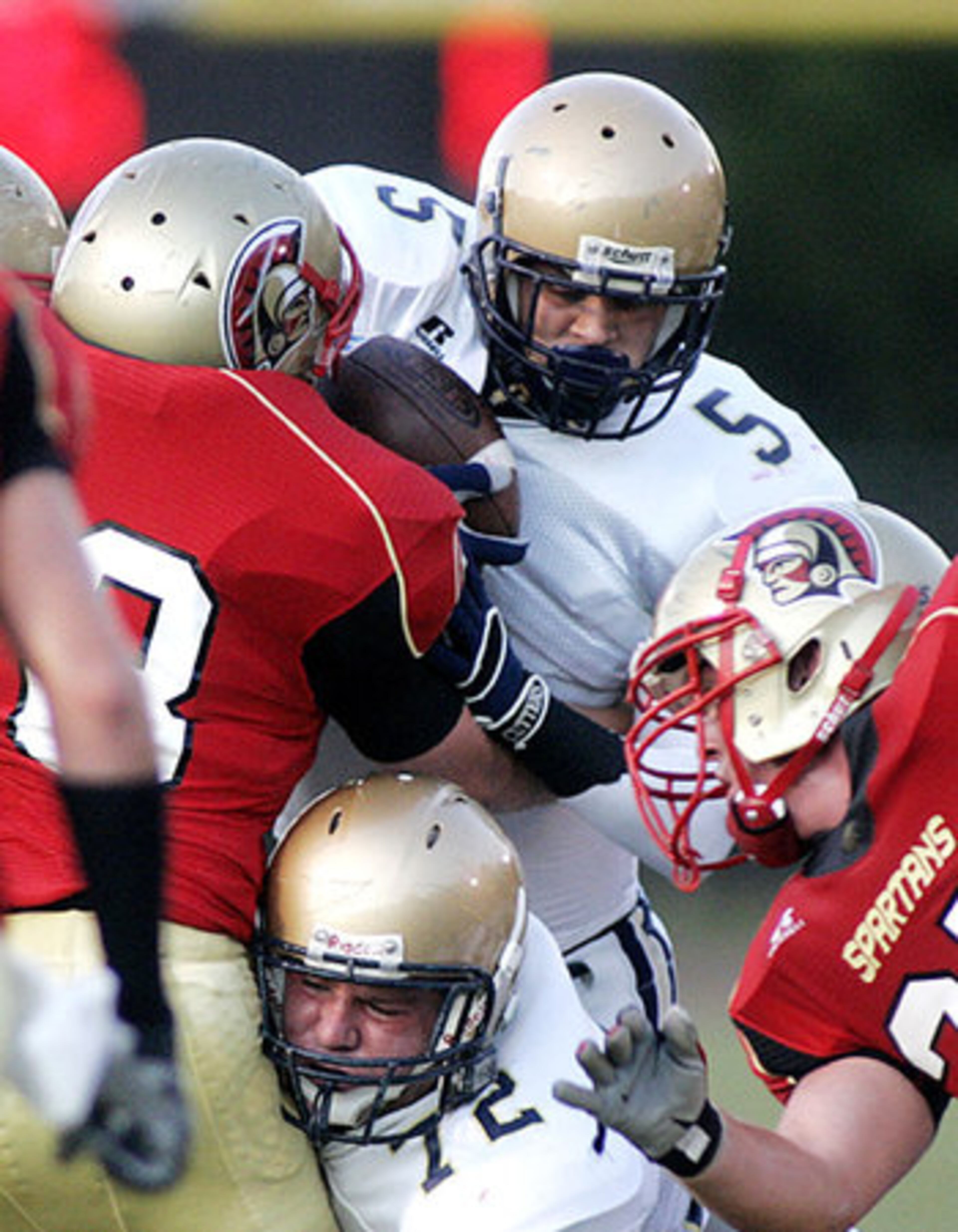 St. Pius running back Cole Moon (5) with assistance from teammate Scott Kramer (72) pushes through the GAC defense.