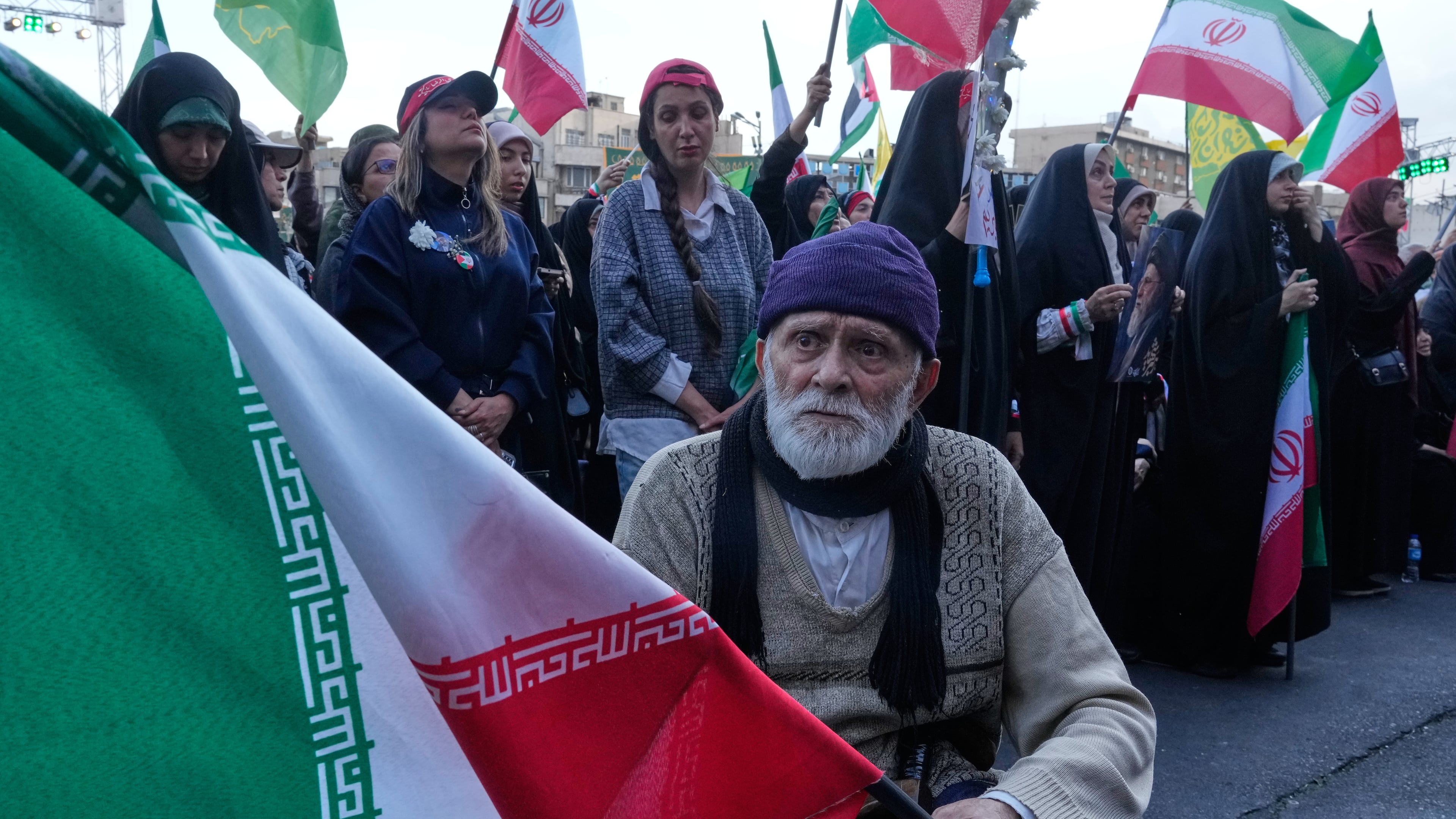A man holds an Iranian flag in a state-organised rally in Tehran, Iran, Wednesday, April 29, 2026, celebrating the birthday of Imam Reza, the 8th Shiite Muslims' Imam, and supporting Iranian Supreme Leader Ayatollah Mojtaba Khamenei. (AP Photo/Vahid Salemi)