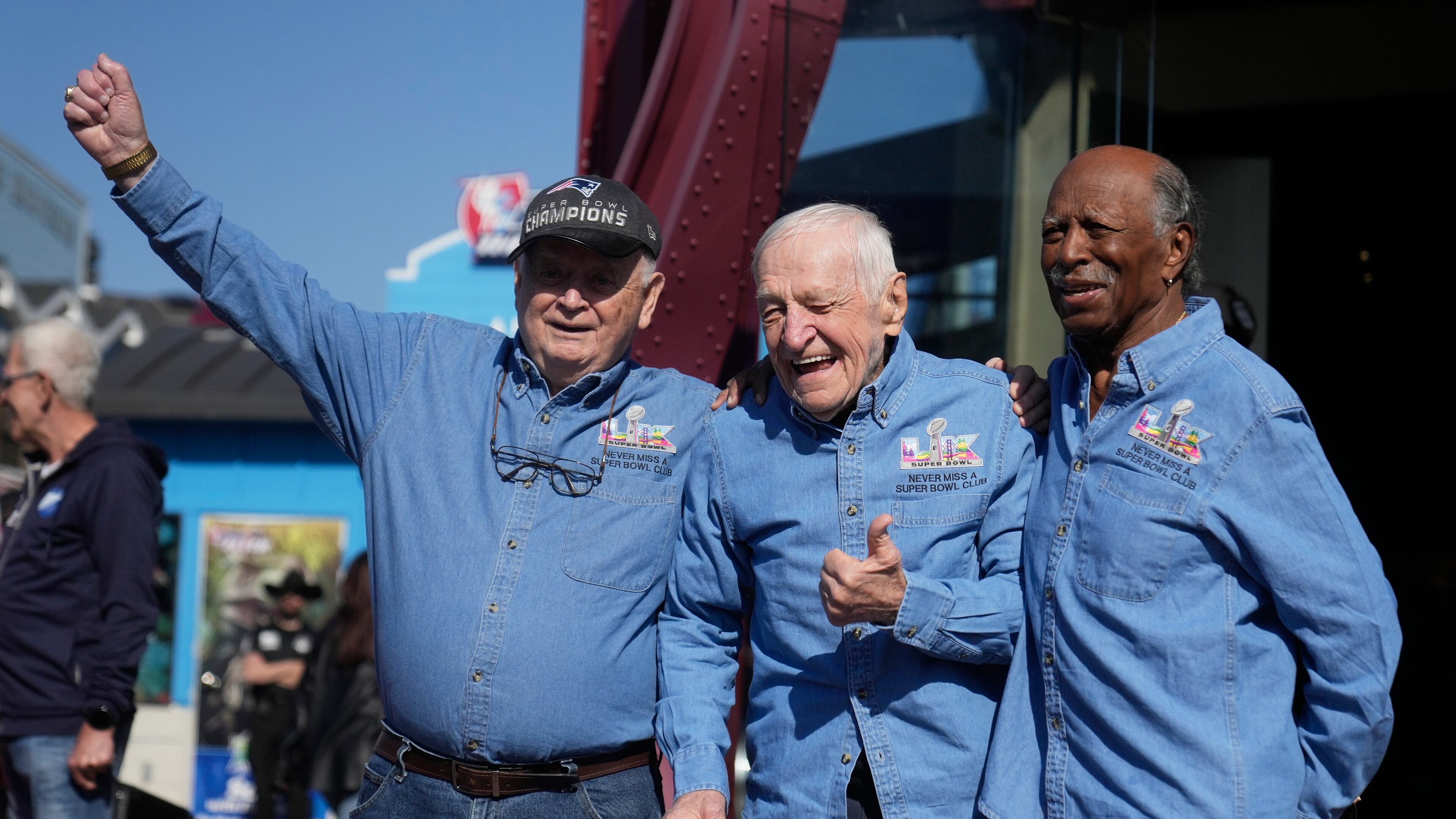 Don Crisman, Tom Henschel and Gregory Eaton, from left, friends who have attended every Super Bowl football game, pose for photos before a news conference at the Hard Rock Cafe in San Francisco, Friday, Feb. 6, 2026. (AP Photo/Jeff Chiu)