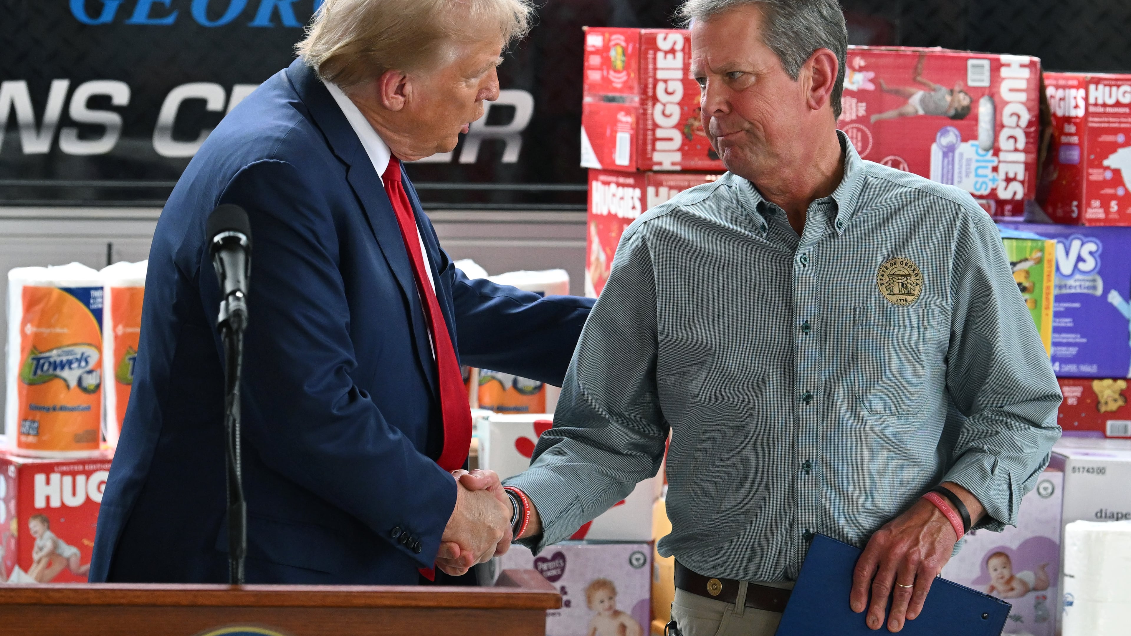 Gov. Brian Kemp greeted Donald Trump ahead of last year's presidential election during Trump's stop in Georgia to survey damage caused by Hurricane Helene. (Hyosub Shin/AJC)