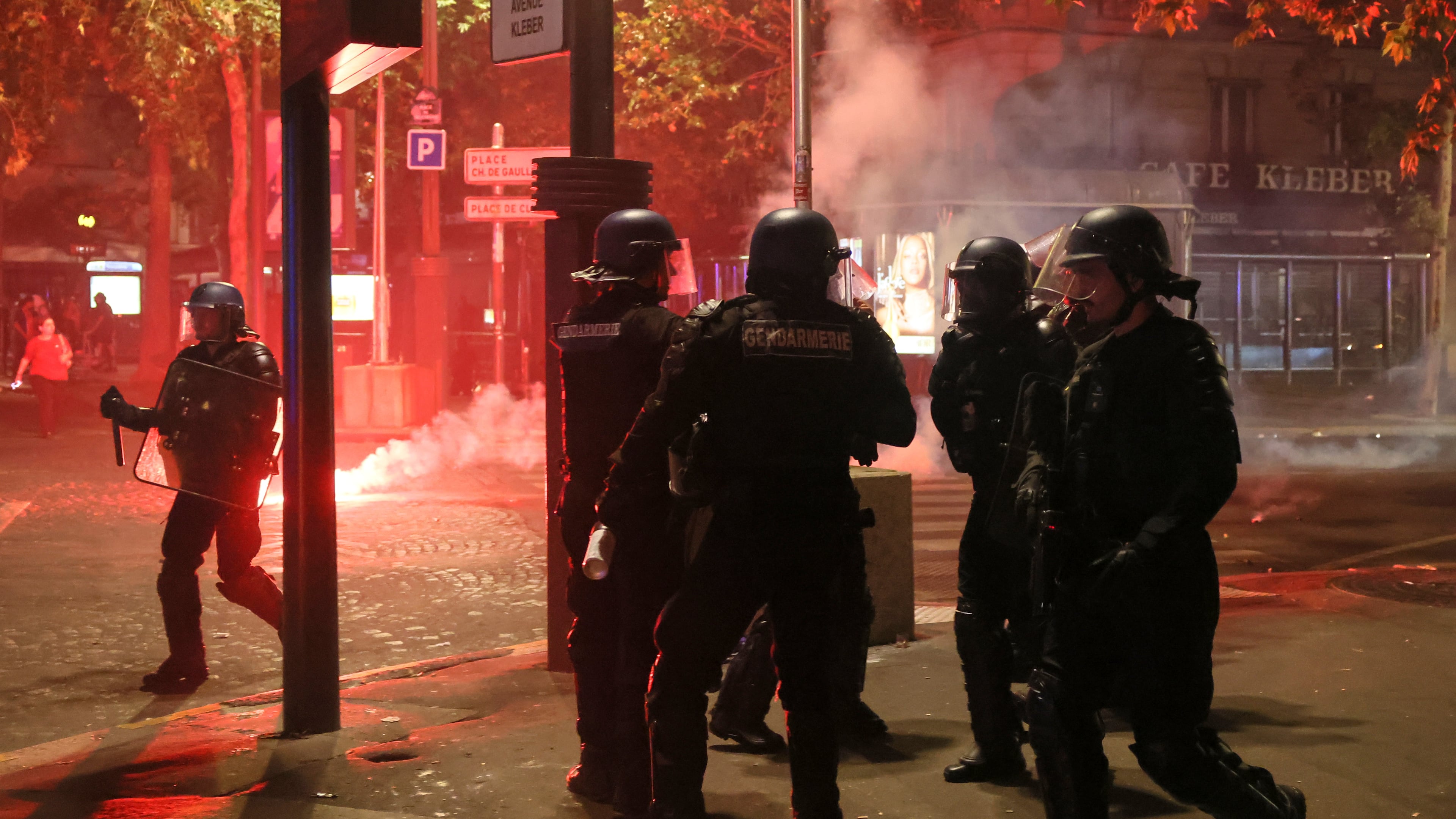 Police try to disperses PSG supporters who left off fireworks as they celebrate in Paris, Saturday, May 30, 2026 after the Champions League final soccer match between Paris Saint-Germain and Arsenal that was played in Budapest, PSG won the game. (AP Photo/Thomas Padilla)
