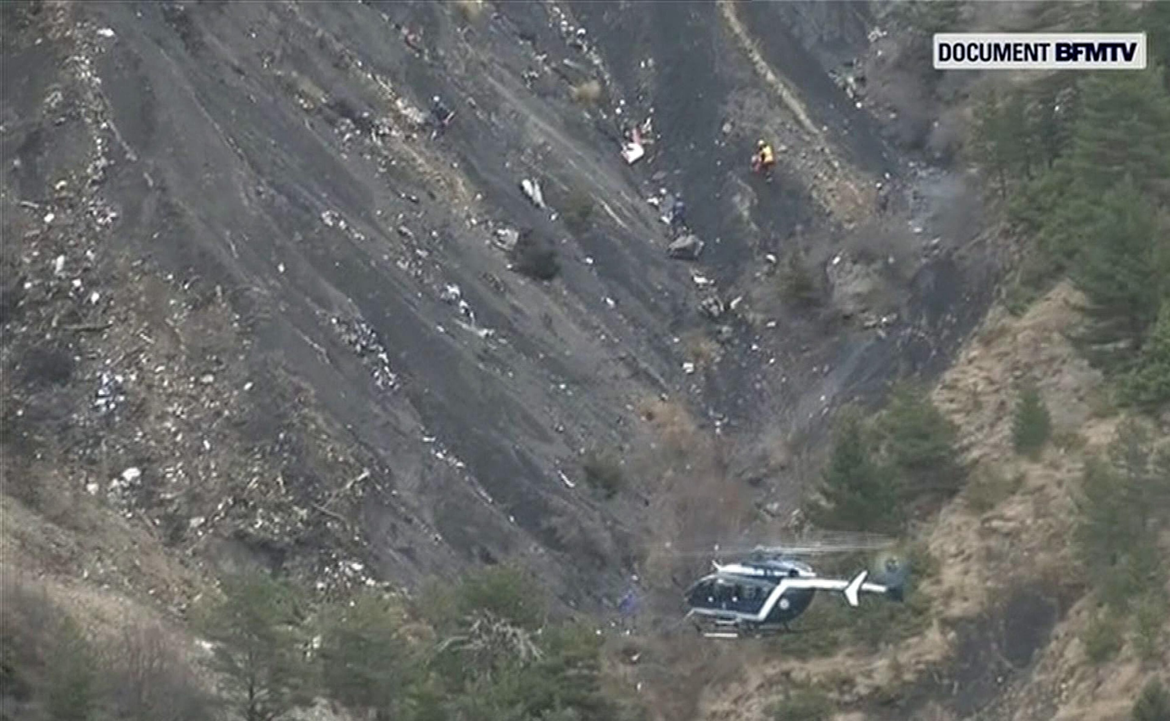 In this image made from TV, debris is scattered over the area after a Germanwings Airbus 320 crashed in the French Alps, Tuesday, March 24, 2015. A Germanwings passenger jet carrying at least 150 people crashed Tuesday in a snowy, remote section of the French Alps, sounding like an avalanche as it scattered pulverized debris across the mountain. (AP Photo / BFMTV) FRANCE OUT TV OUT