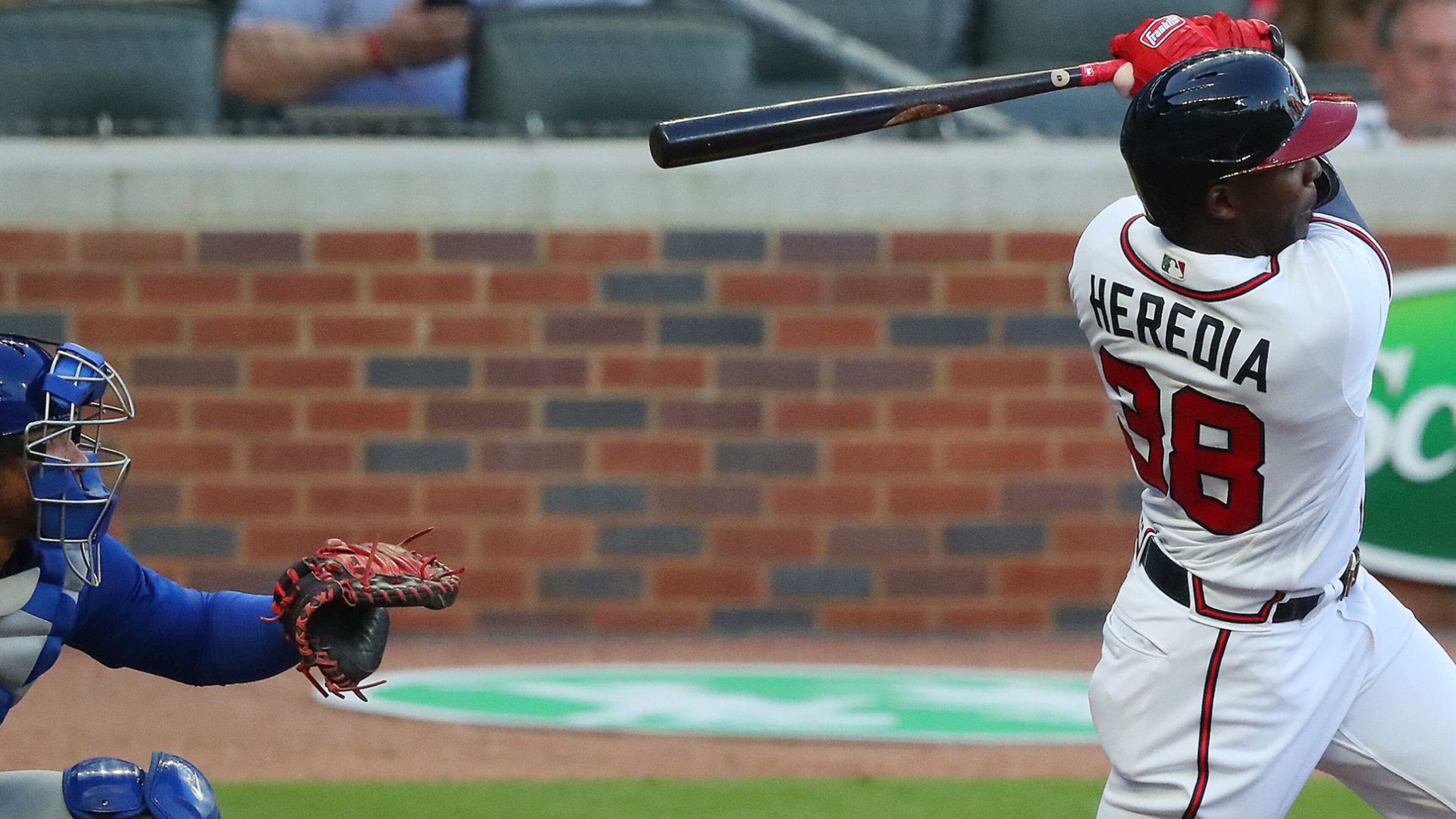 Braves outfielder Guillermo Heredia hits an RBI double to give Atlanta a 4-0 lead in the first inning Monday, April 26, 2021, against the Chicago Cubs at Truist Park in Atlanta. (Curtis Compton / Curtis.Compton@ajc.com)