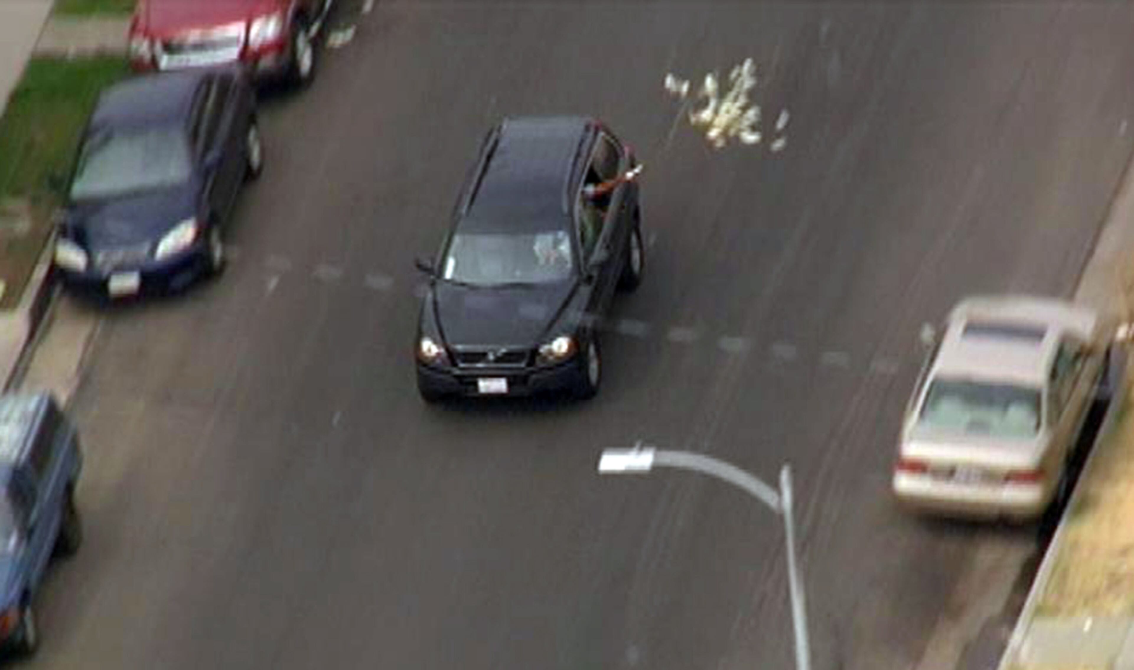 MONEY ON THE RUN--This image provided by KNBC-TV shows bank robbery suspects throwing money from their vehicle during a police pursuit Wednesday Sept. 12, 2012 in Los Angeles. The vehicle was eventually blocked by another vehicle and the suspects were arrested.
