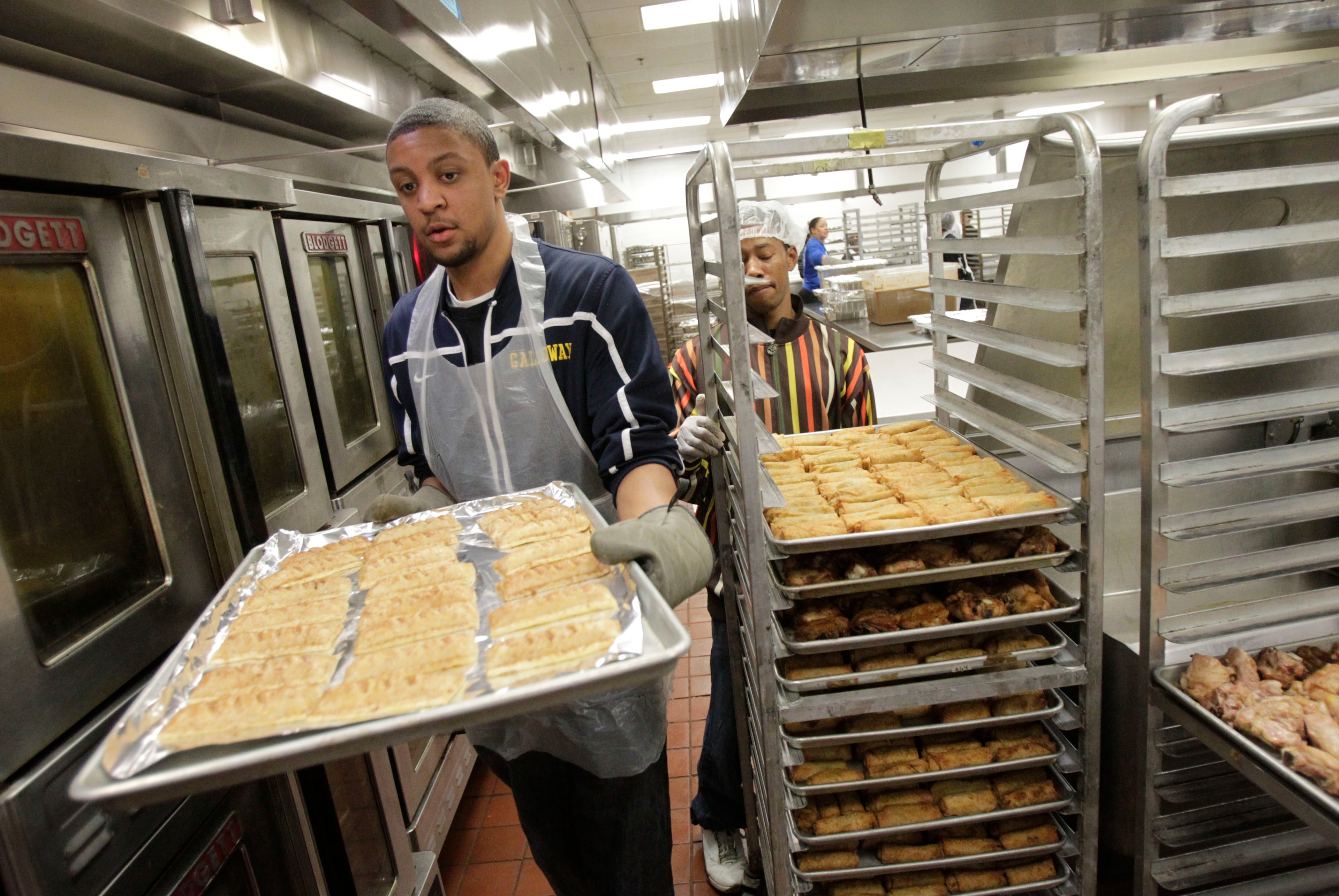 Volunteer Johvonn Smith bakes pastries in the kitchen.