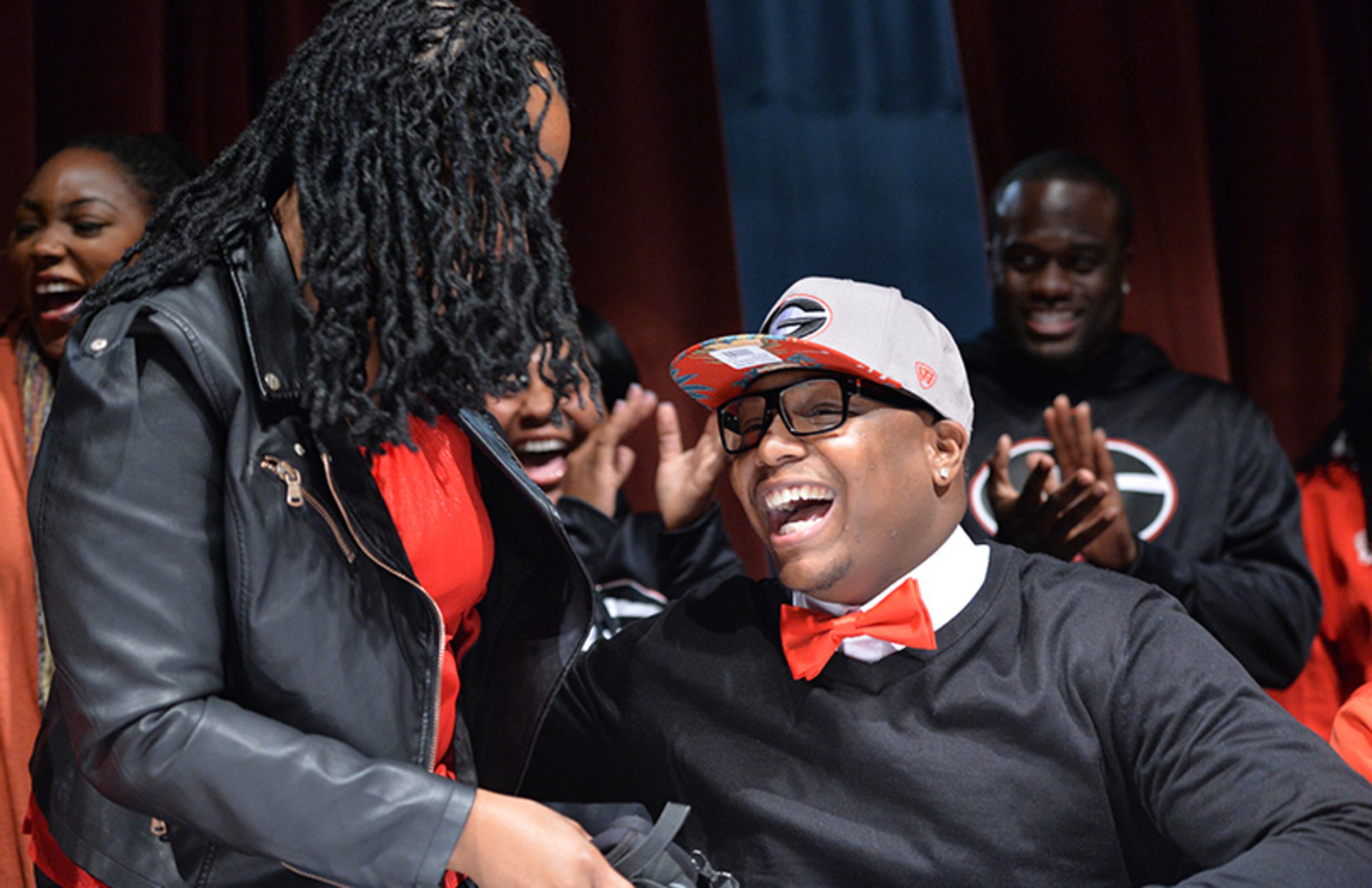 Detric Bing-Dukes celebrates with his mother Demetrius Dukes (left) after he signs with the University of Georgia during signing day festivities at Tucker High School.