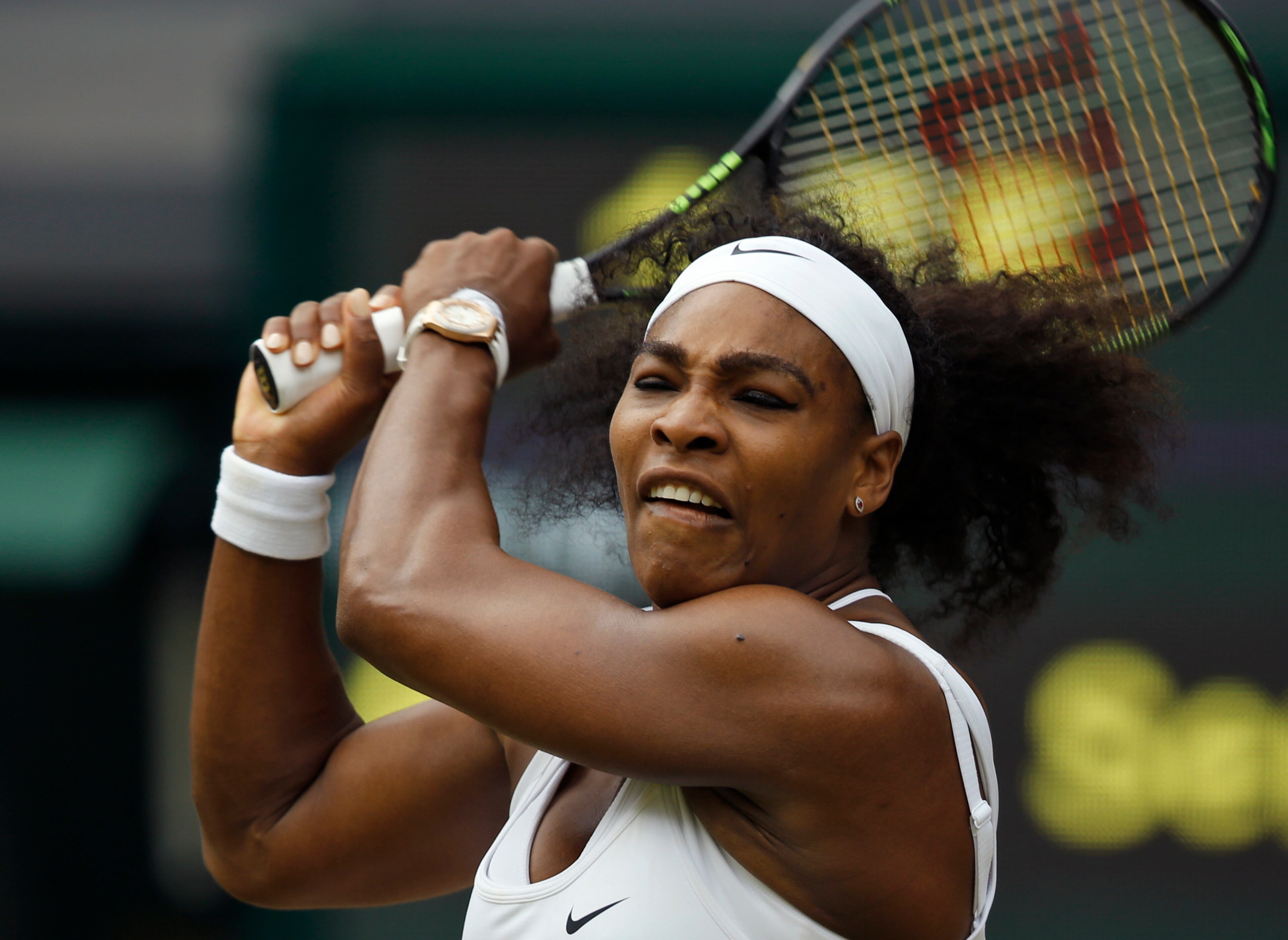 Serena Williams of the United States makes a return to Venus Williams of the United States, during their singles match against at the All England Lawn Tennis Championships in Wimbledon, London, Monday July 6, 2015. (AP Photo/Alastair Grant)