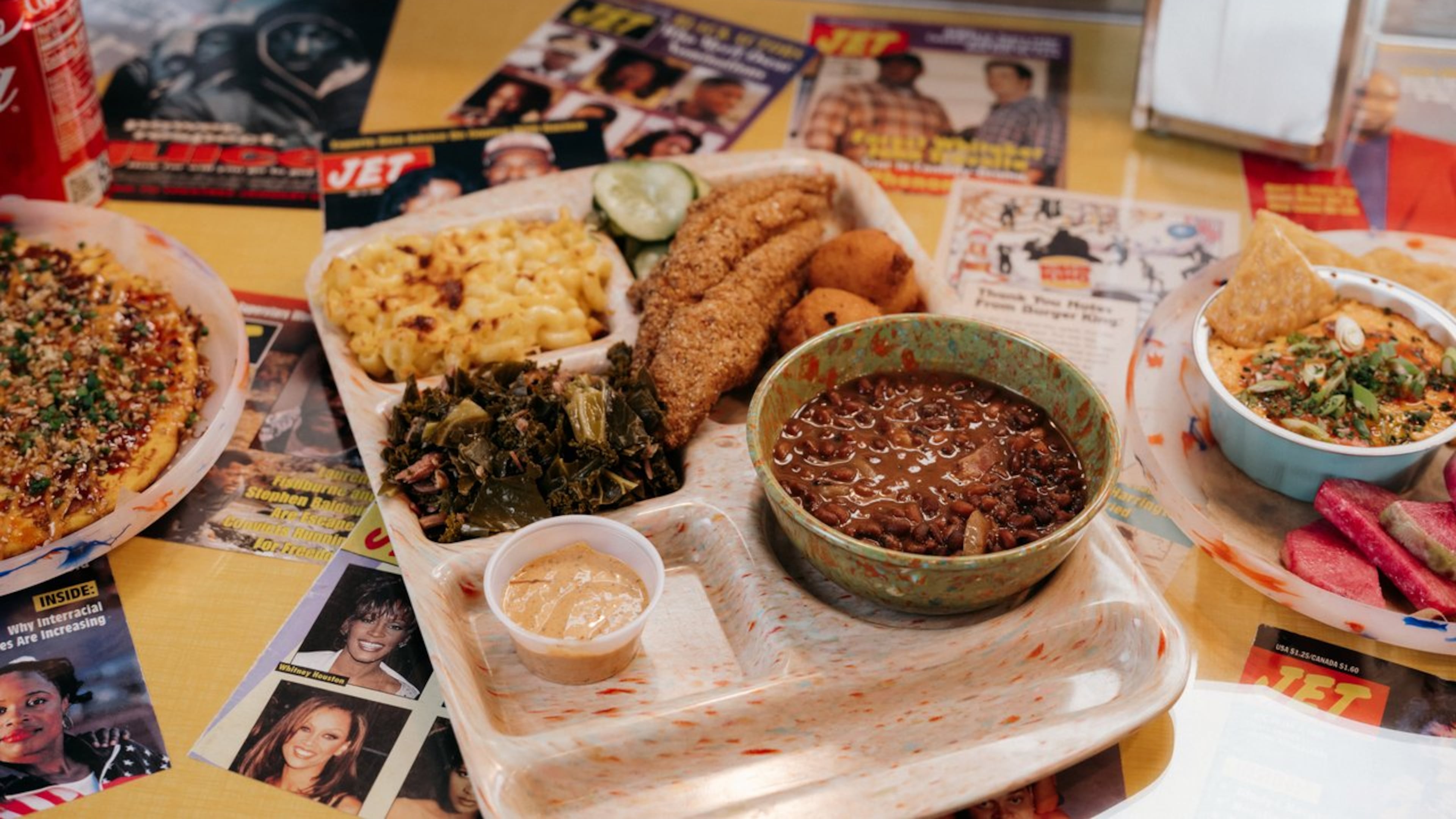 This catfish platter at Good Hot Fish includes Sea Island red peas, stewed greens, macaroni and cheese, refrigerator pickles, hush puppies and tartar sauce. Courtesy of Good Hot Fish