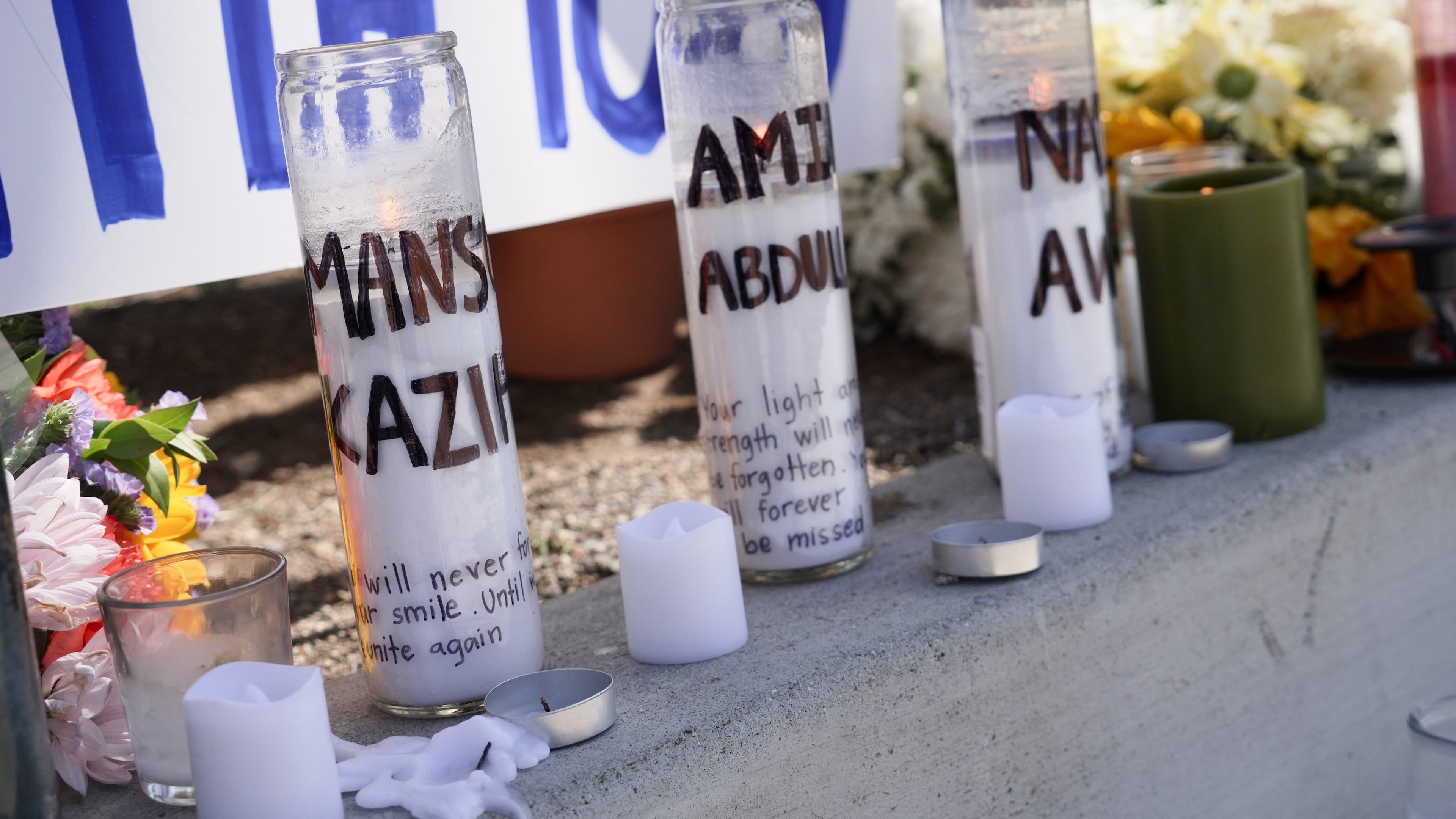 Candles with victims names are placed outside the Islamic Center of San Diego in the aftermath of a shooting on Wednesday, May 20, 2026, in San Diego. (AP Photo/Ty Oneil)