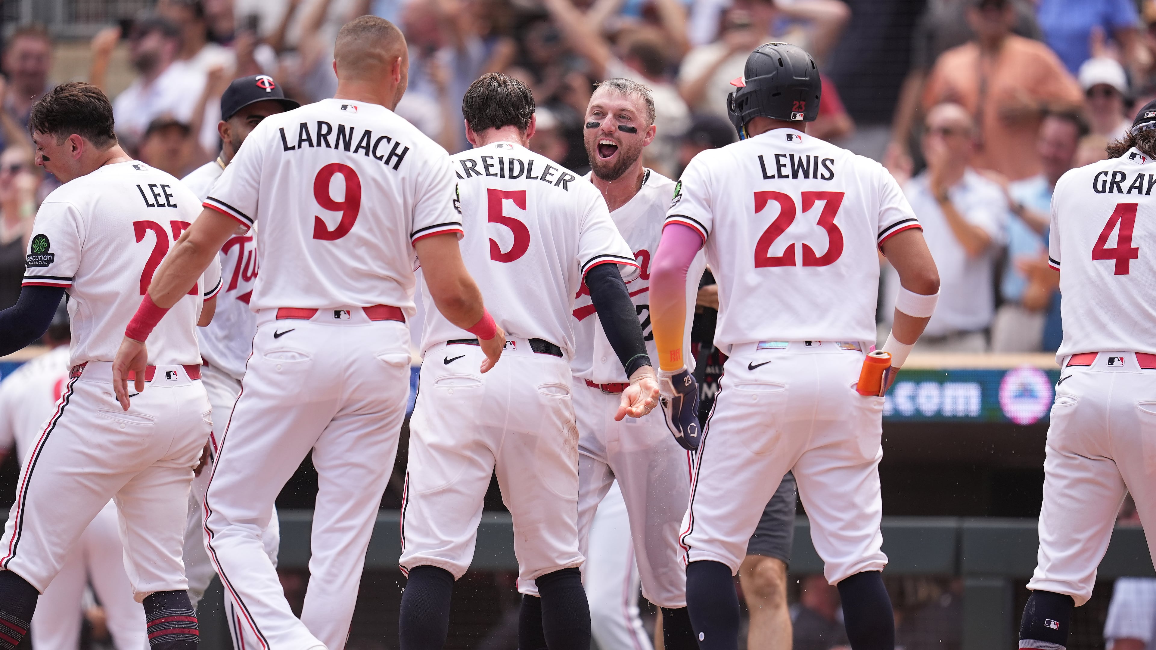 Minnesota Twins' Kody Clemens, back, middle, celebrates with teammates after hitting a walk-off grand slam during the ninth inning of a baseball game against the Kansas City Royals Thursday, July 30, 2026, in Minneapolis. (AP Photo/Abbie Parr)