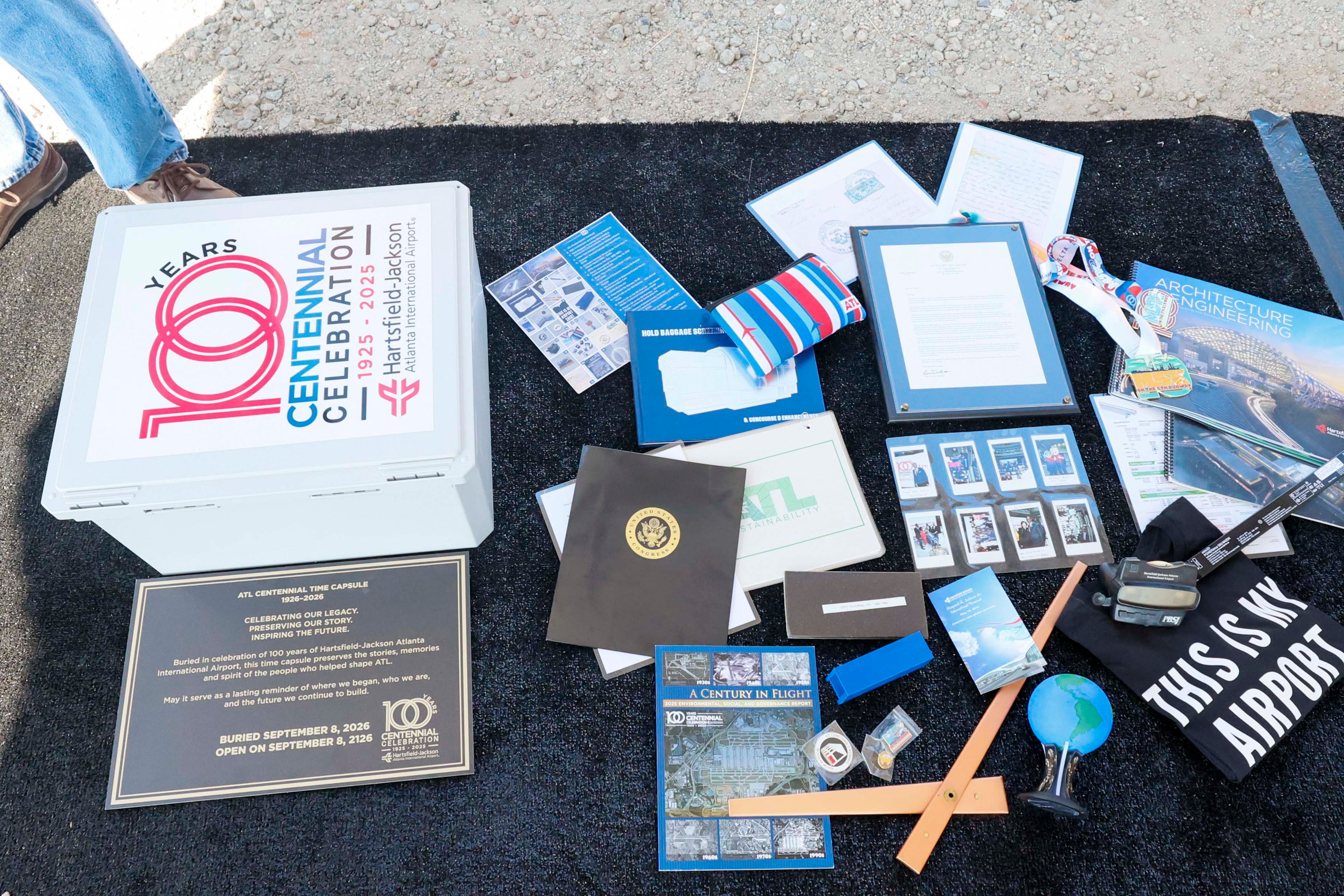 More than 20 items that tell the story of the airport's evolution are on display before they go into the time capsule on the airfield at Stogner Hill at Hartsfield-Jackson Atlanta International Airport on Tuesday, Sep. 8, 2026. The event commemorates ATL’s 100th anniversary. (Miguel Martinez/ AJC)